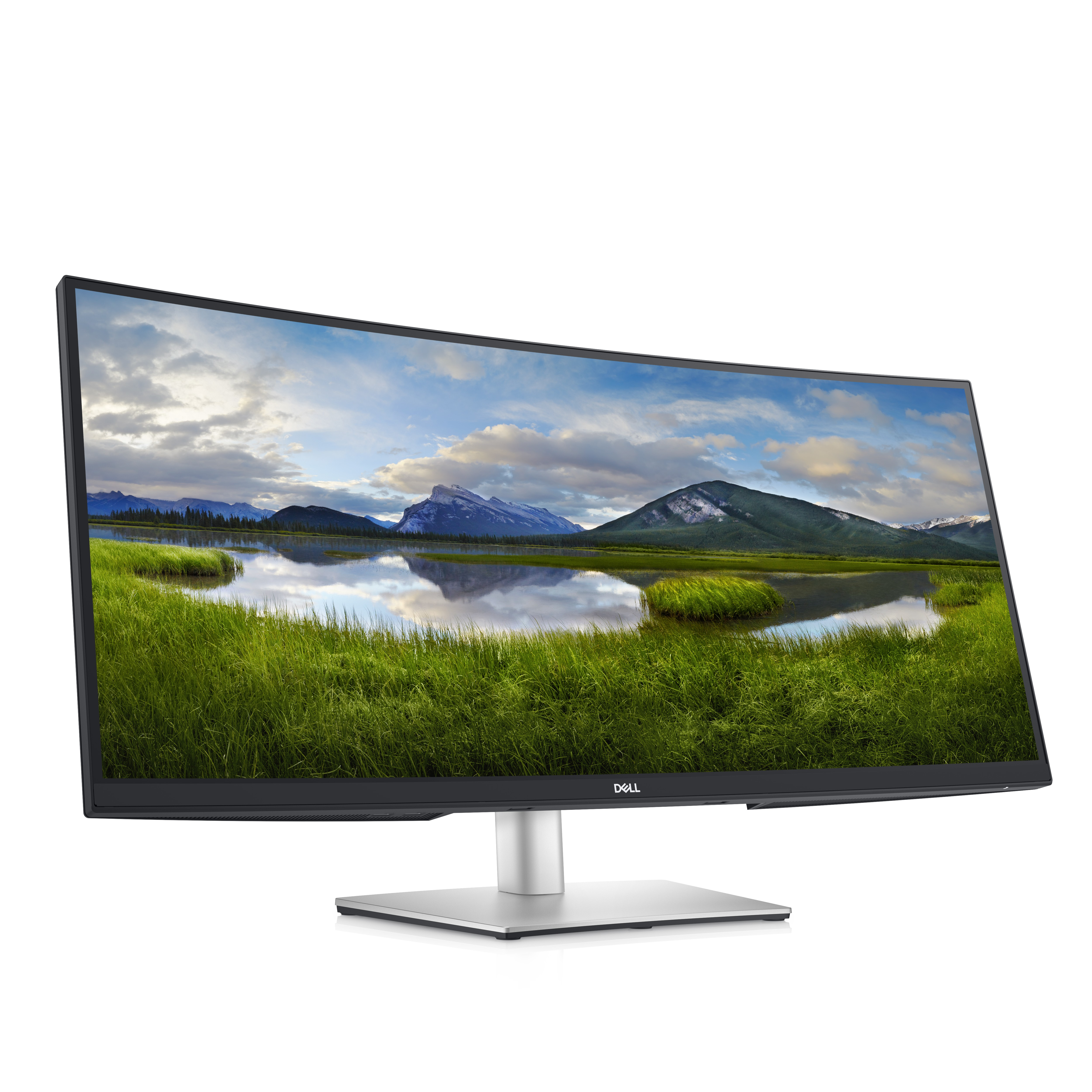 Monitor curvo Dell, mostrando un paisaje de hierba y montañas. Soporte plateado. Fondo blanco.