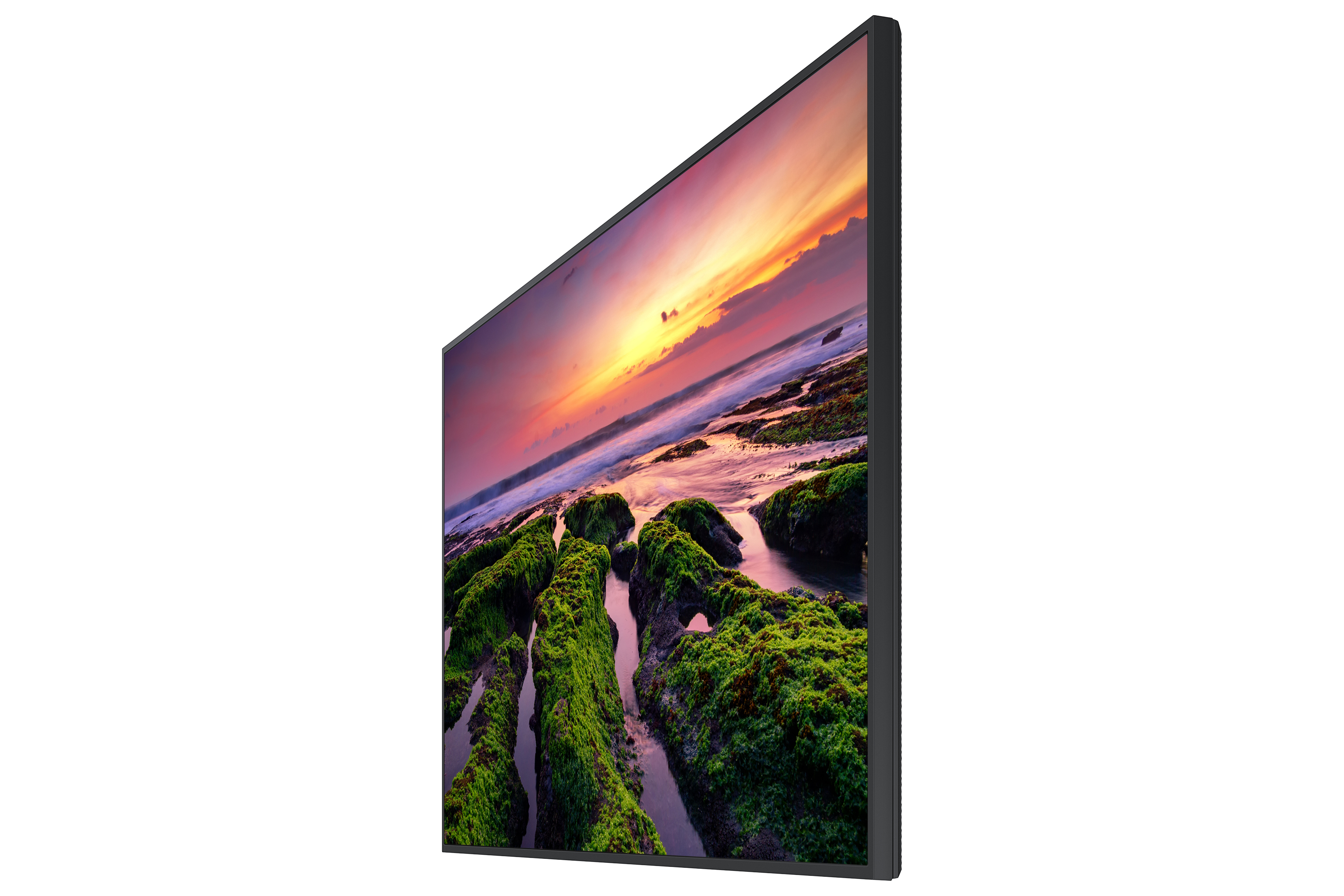 Seitenansicht eines Monitors mit Sonnenuntergang über Felsen und Meer. Der Bildschirm ist schwarz umrahmt.