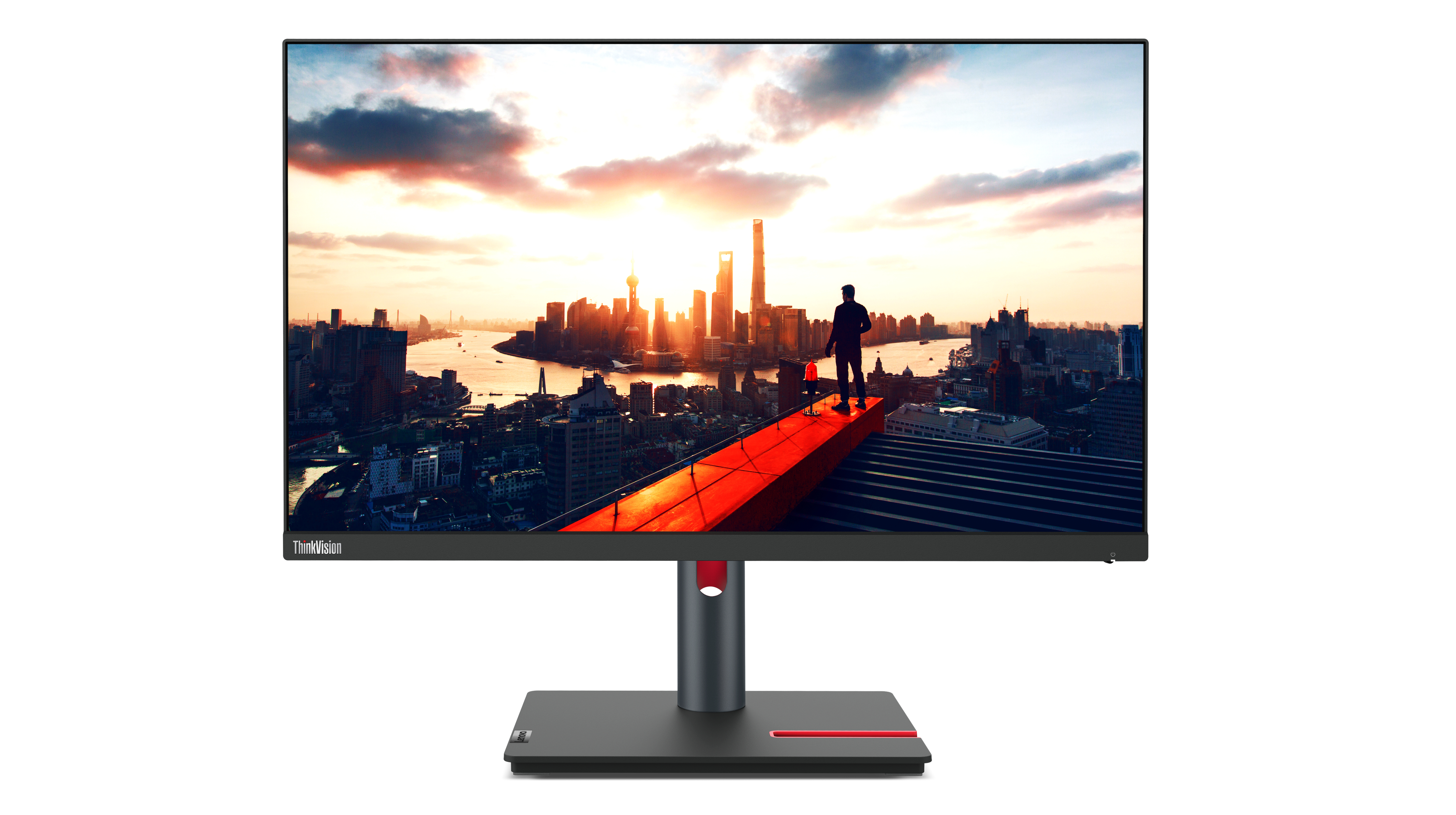 Lenovo-Monitor zeigt Skyline bei Sonnenuntergang mit Person oben.