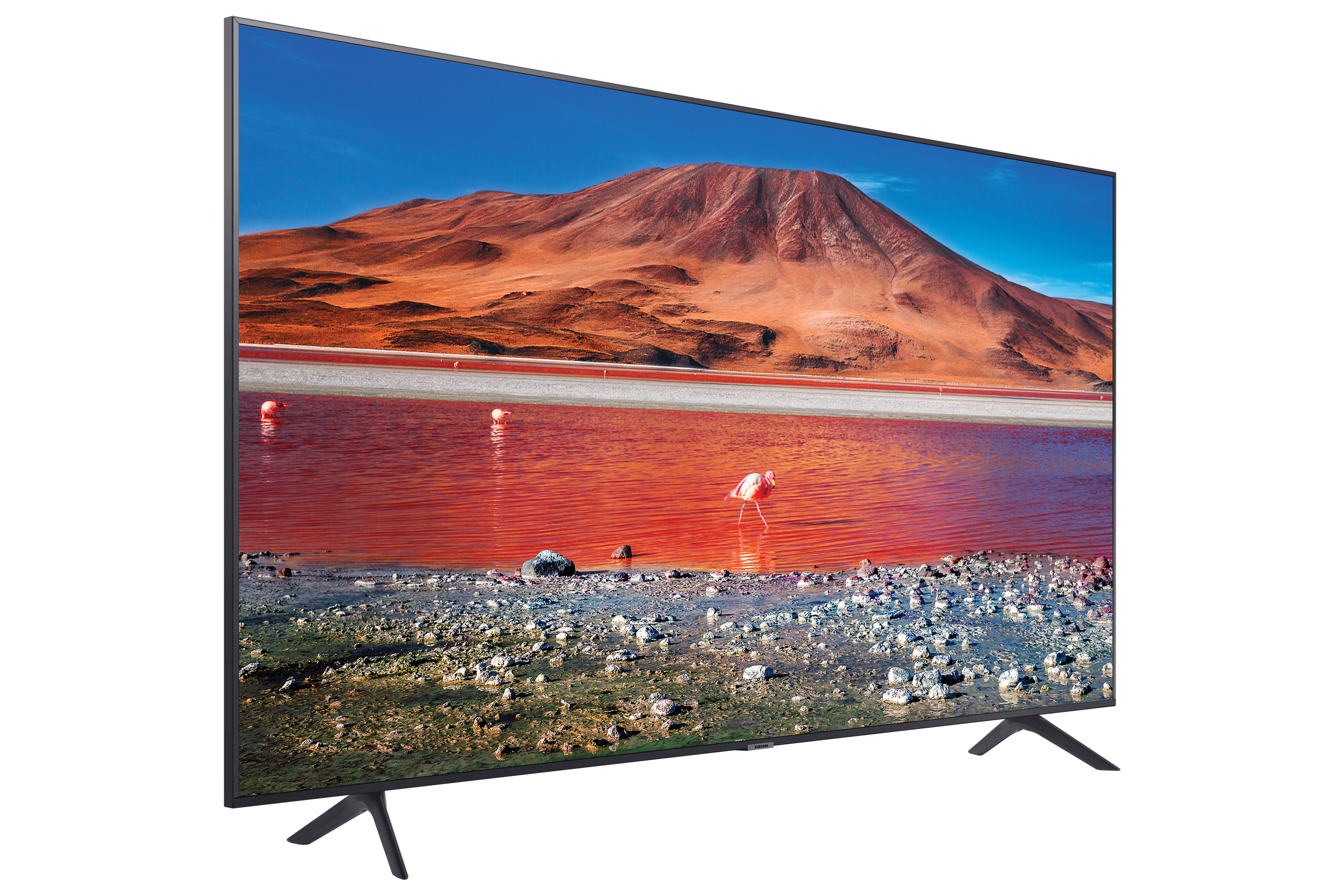 Un televisor grande que muestra un paisaje escénico, con un lago rojo y montañas al fondo.