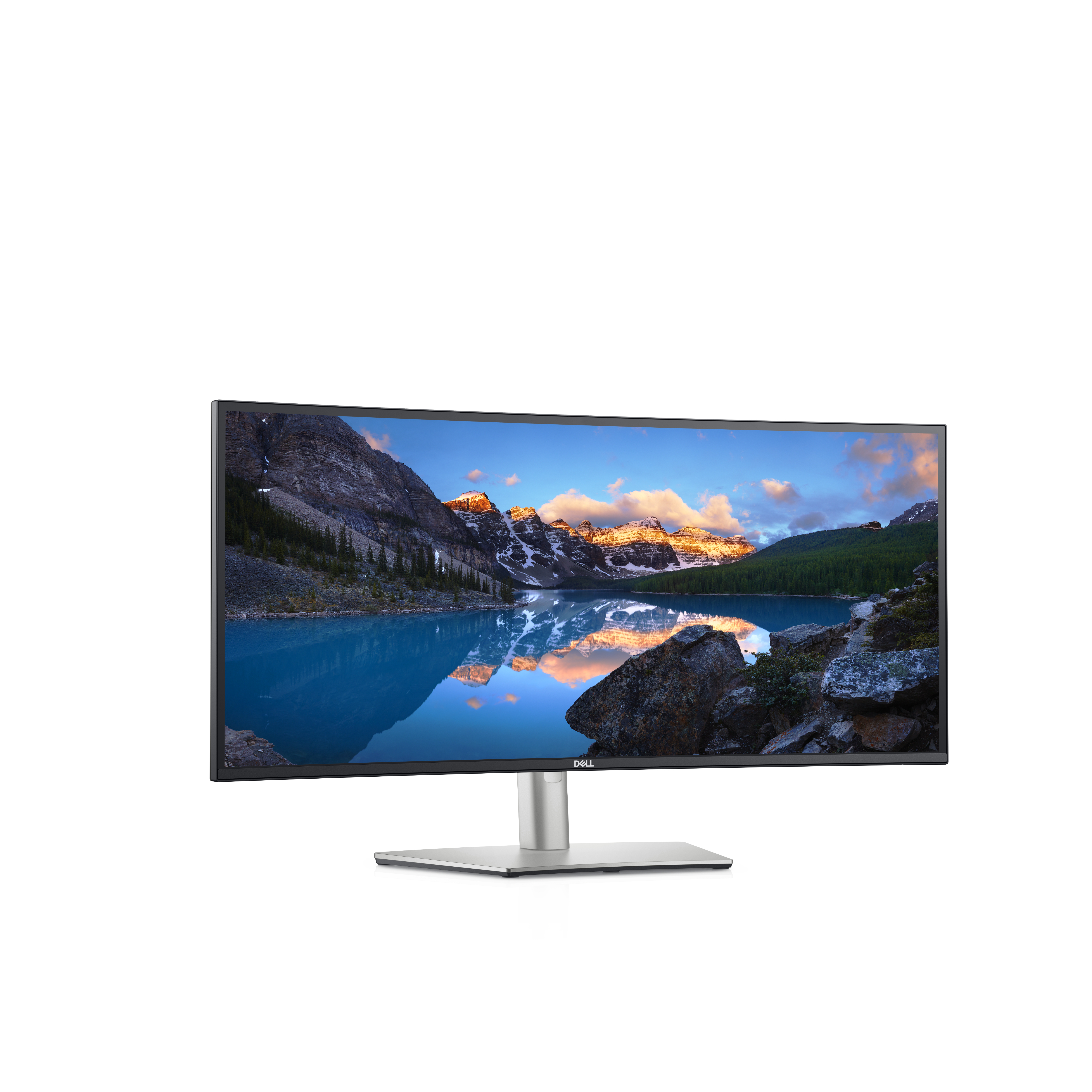 Ein Dell-Monitor zeigt eine ruhige Landschaft eines Sees, umgeben von Bergen unter blauem Himmel.