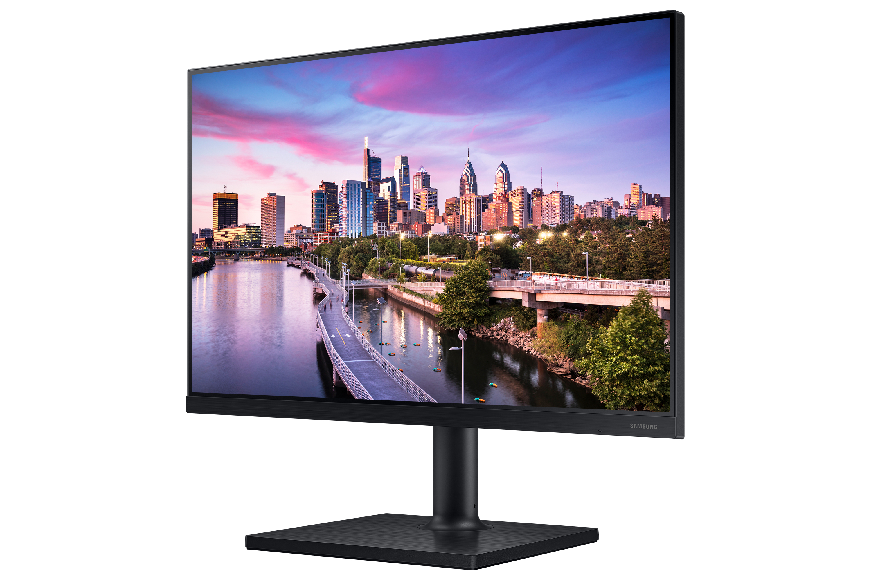 El monitor muestra el horizonte de una ciudad. Base y marco negros. El cielo es rosa y azul.