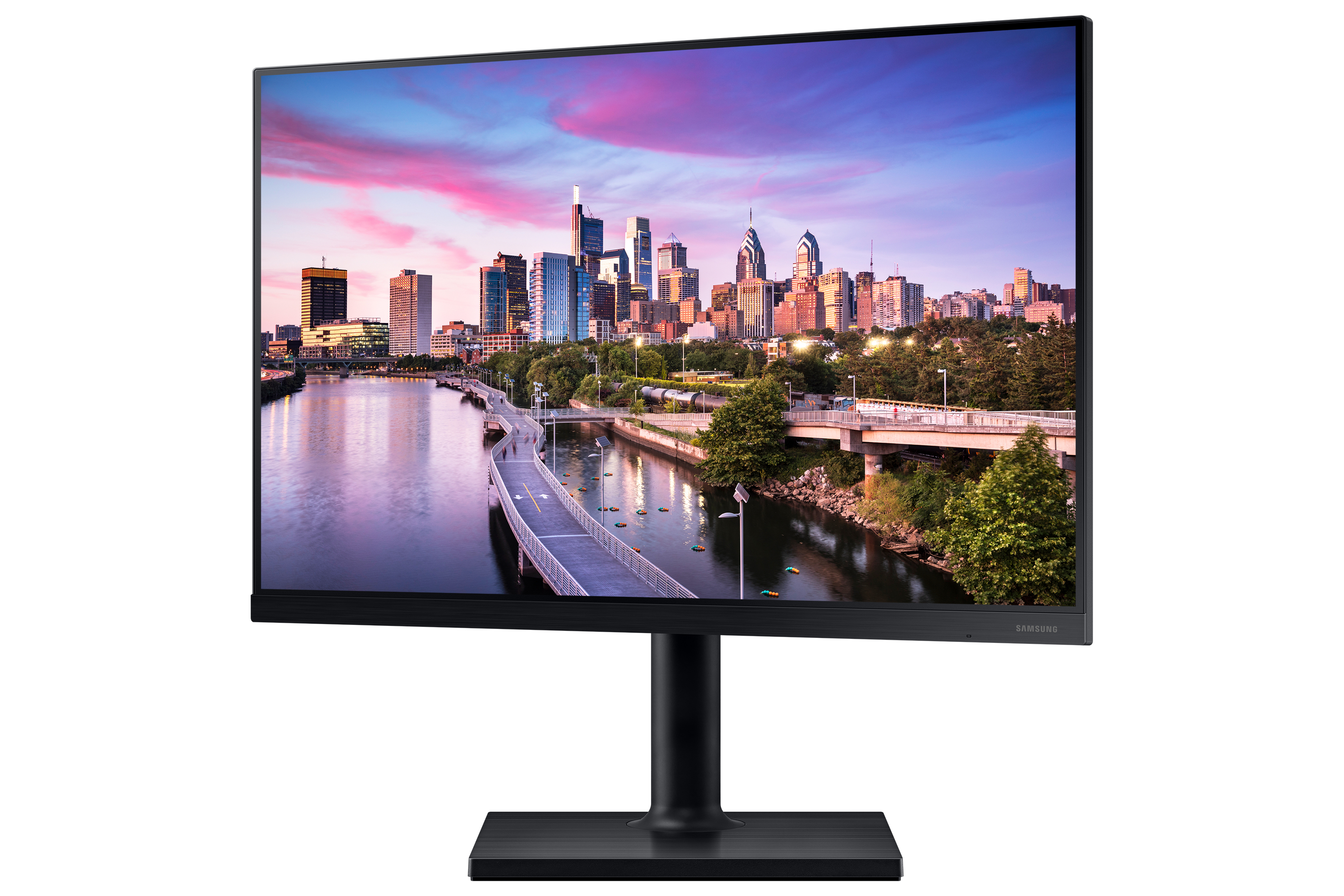 Un monitor negro que muestra un horizonte de la ciudad, con un puente y agua en primer plano.