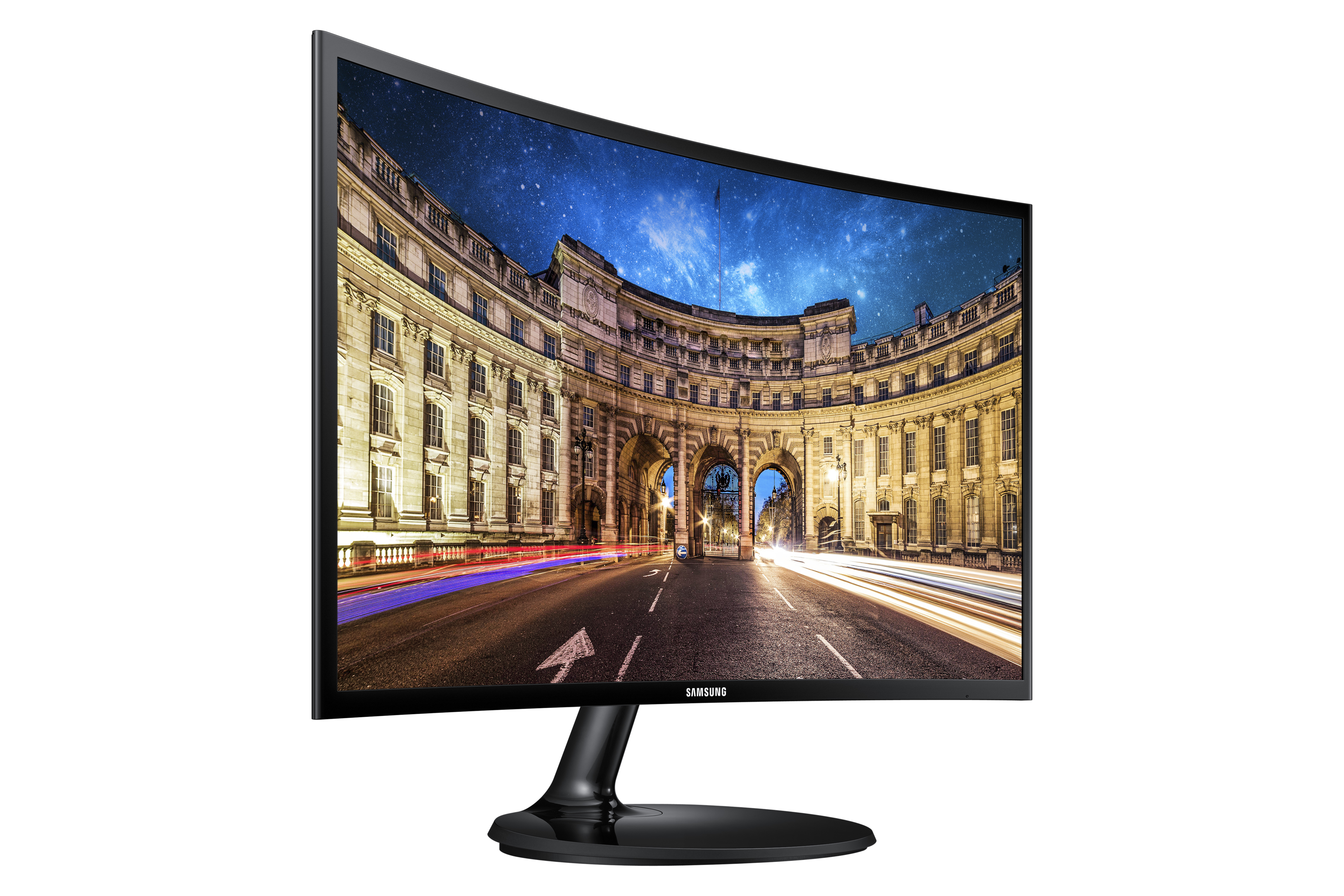 Monitor curvo che mostra una scena di strada con edifici e cielo notturno.
