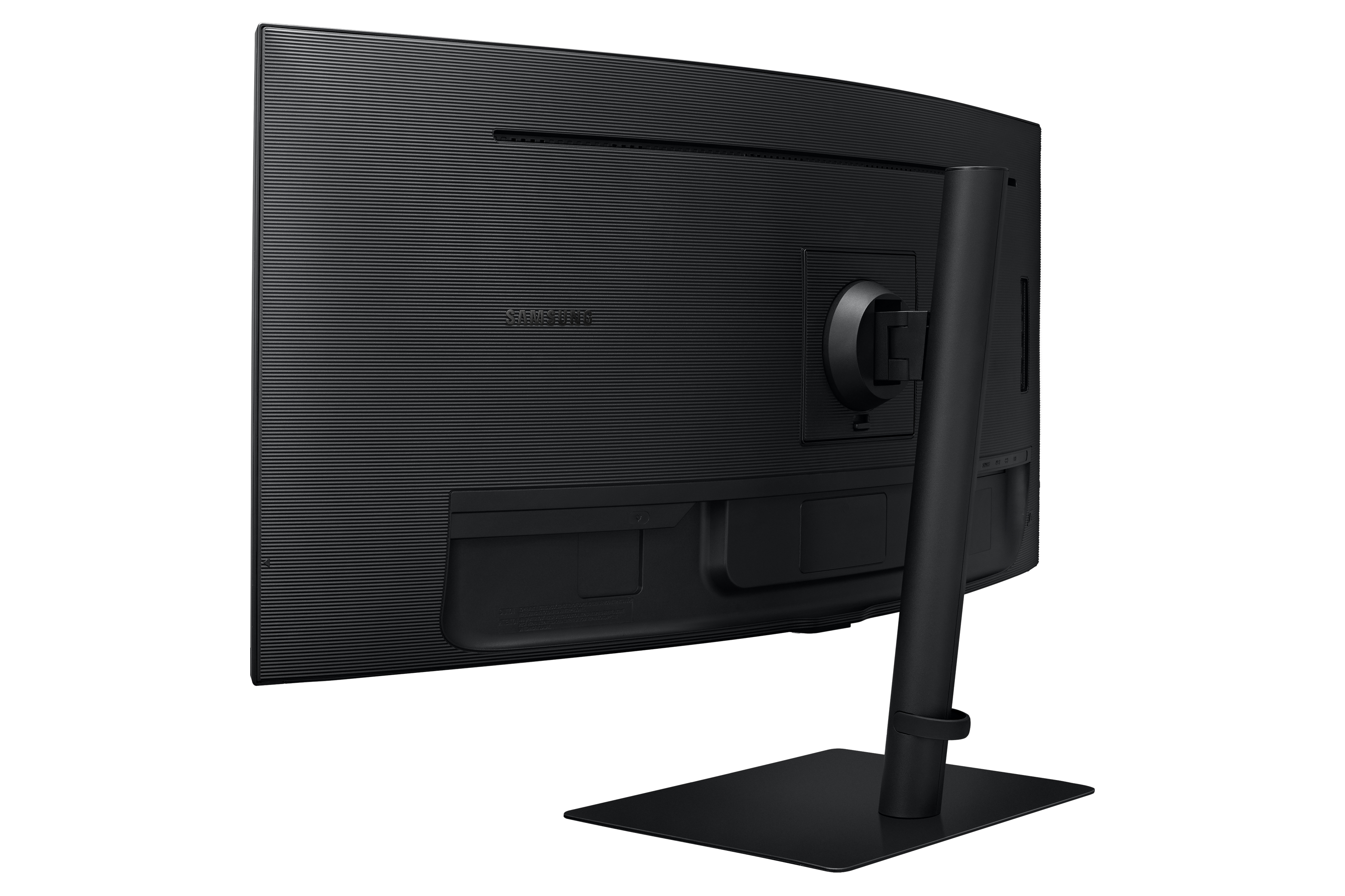 Back of a black Samsung monitor. The stand is off-center. It has an interesting texture.