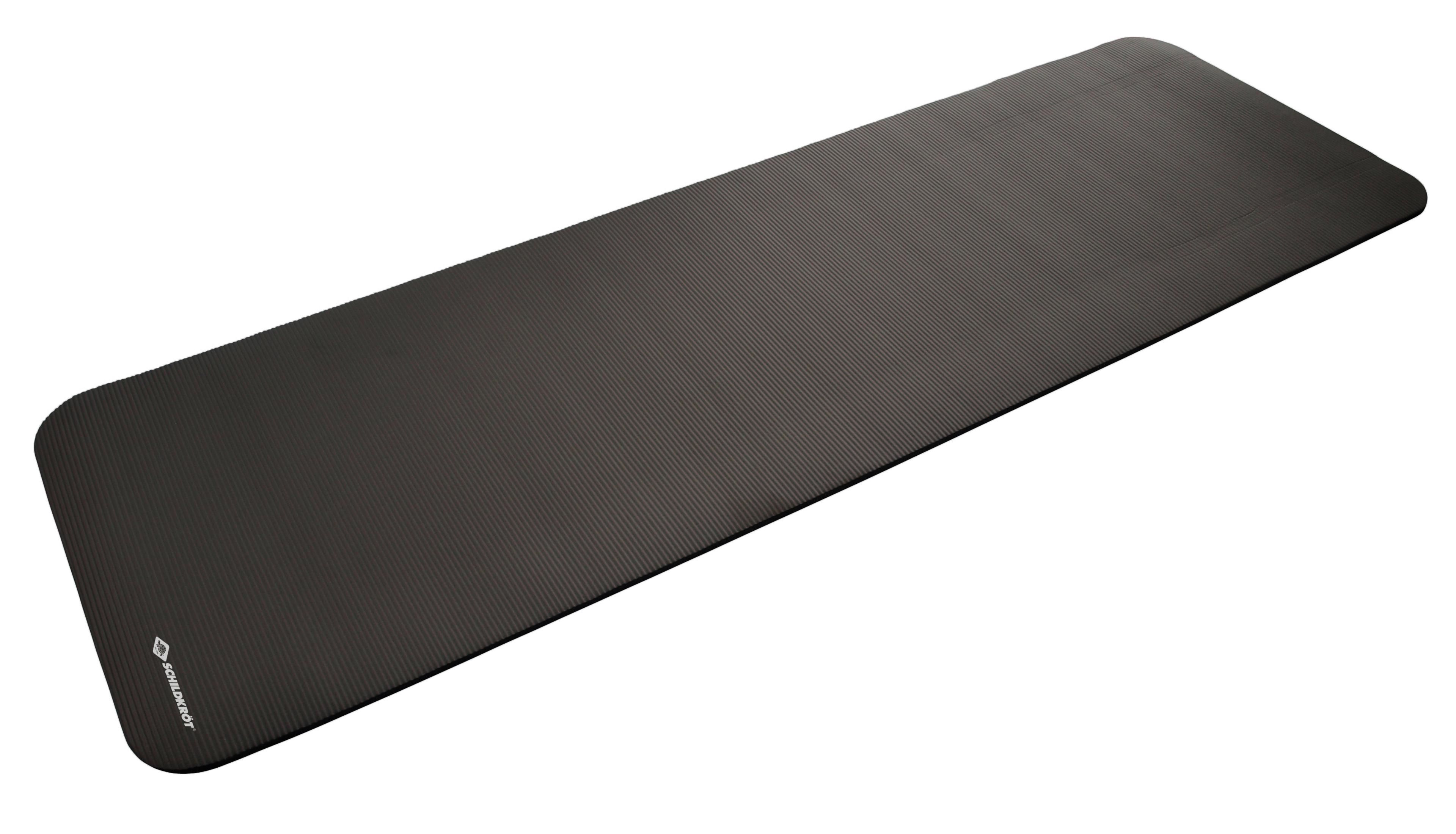 Eine schwarze Yogamatte auf einer weißen Oberfläche. Es ist ein langes Rechteck mit strukturierter Oberfläche.