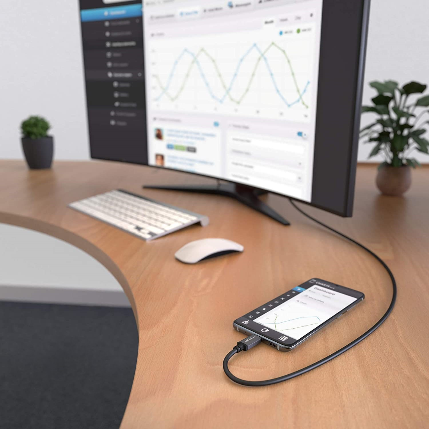 Un smartphone connecté à un moniteur via un câble, affichant un graphique.