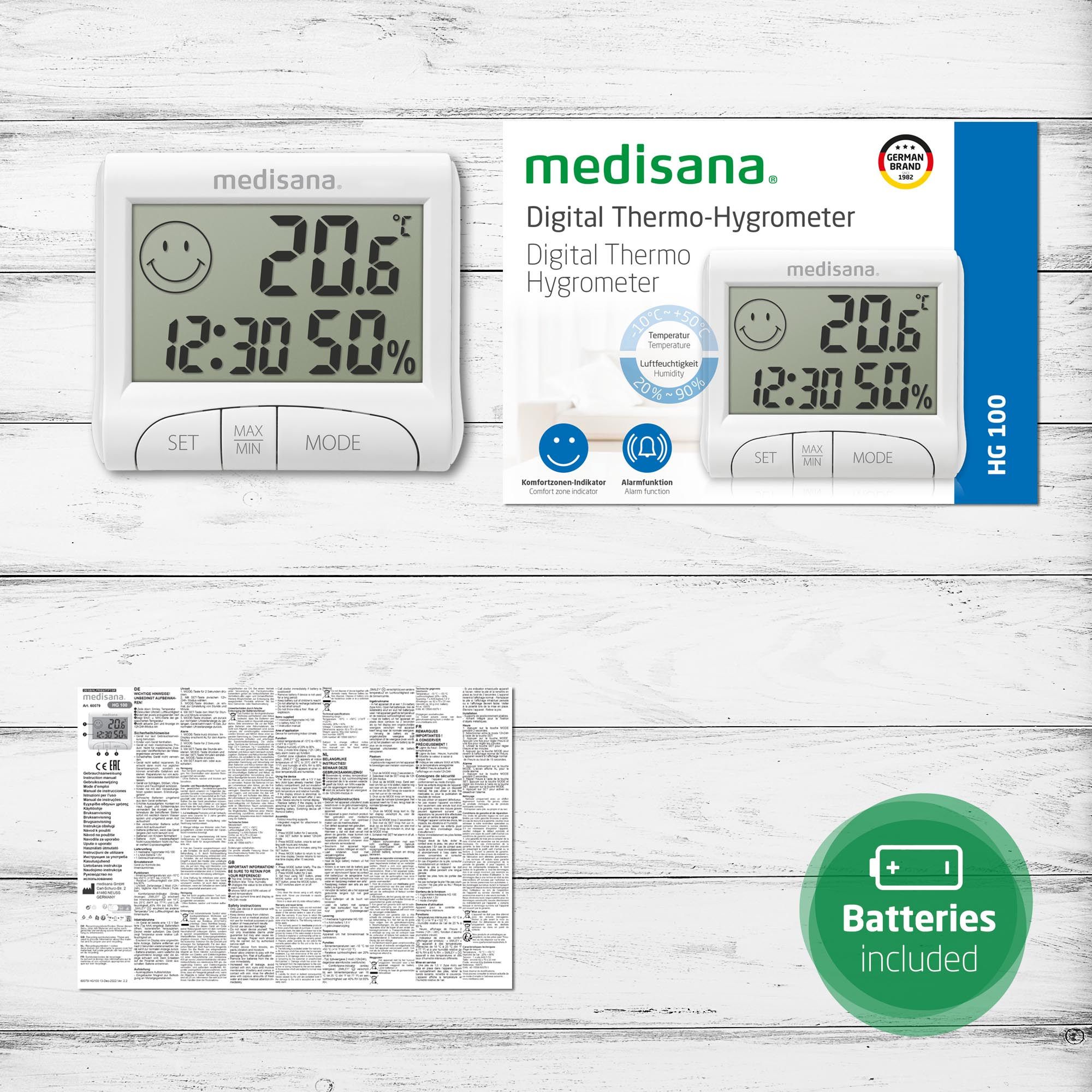 Weißes Digitalthermometer mit Anzeige von Uhrzeit, Luftfeuchtigkeit und Temperatur sowie eine Box mit Produktdetails.