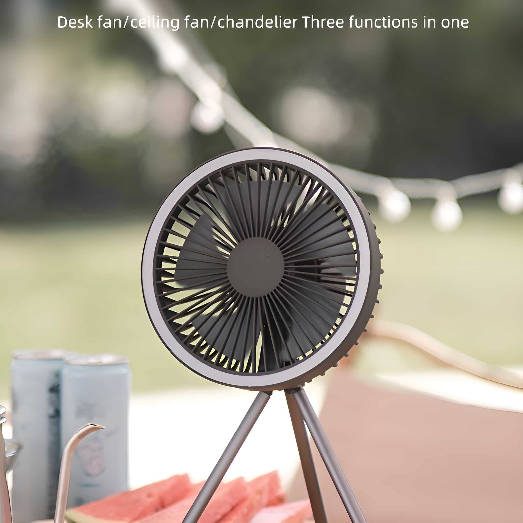 Ein schwarzer Ventilator mit weißem LED-Ring steht auf einem Stativ. Rote Wassermelone ist nah.