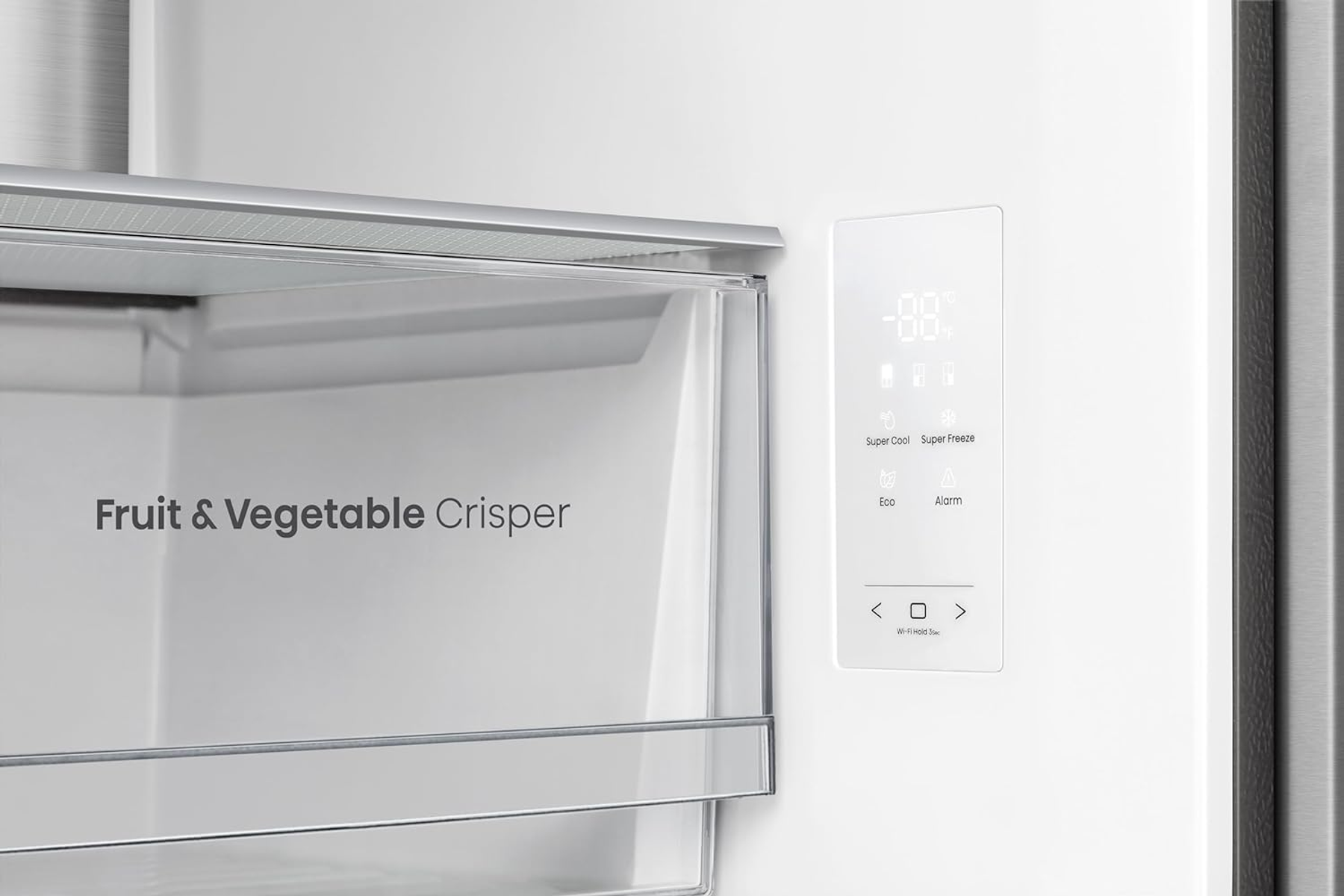 Zbliżenie wnętrza lodówki. Widoczna szuflada z napisem 'Owoce i Warzywa'.