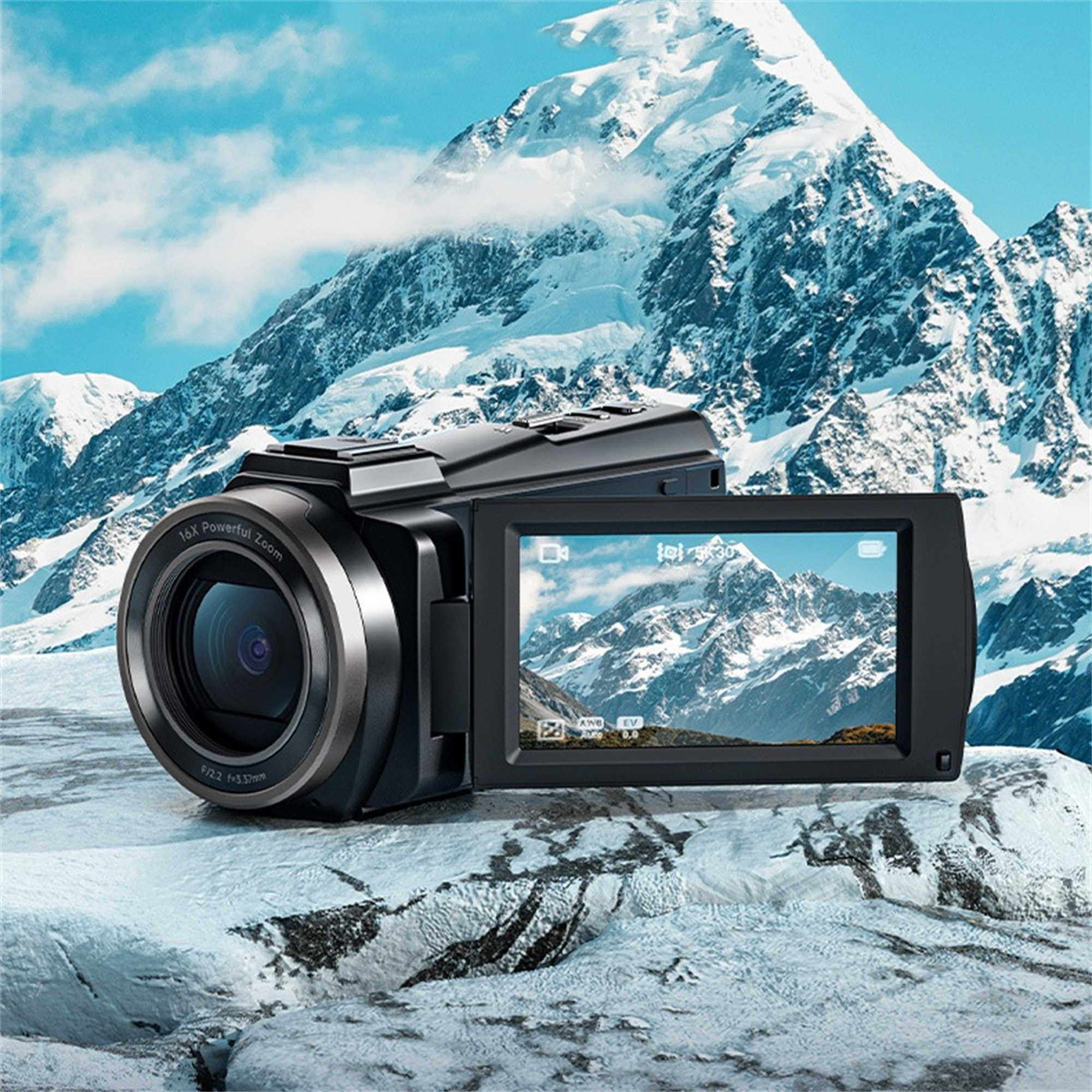 Eine Videokamera, die auf ihrem Bildschirm eine Berglandschaft zeigt, mit schneebedecktem Hintergrund.
