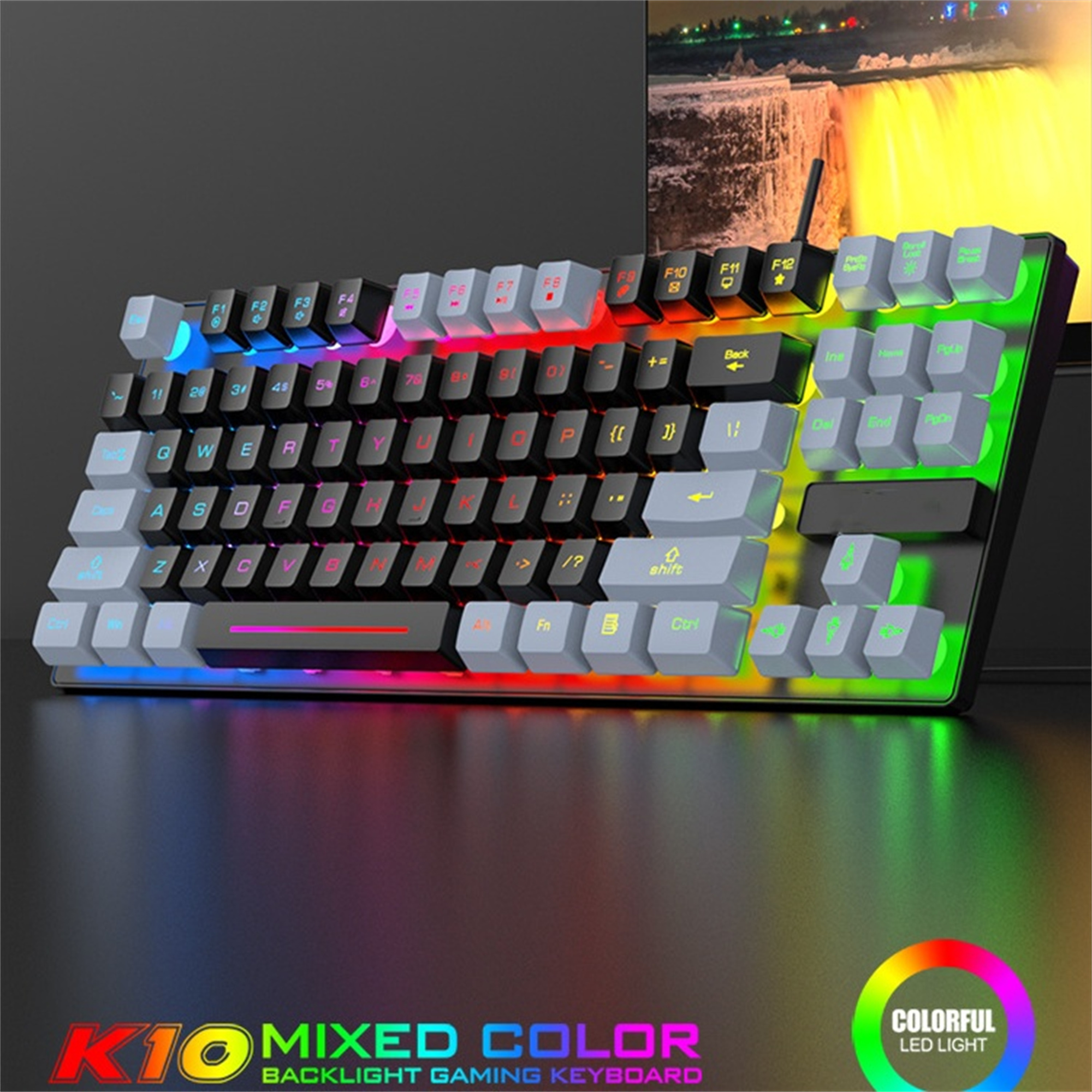 Gaming-Tastatur mit bunten Tasten, beleuchtet, mit schwarzem Gehäuse, mit LED-Licht und Wasserfall-Hintergrund.