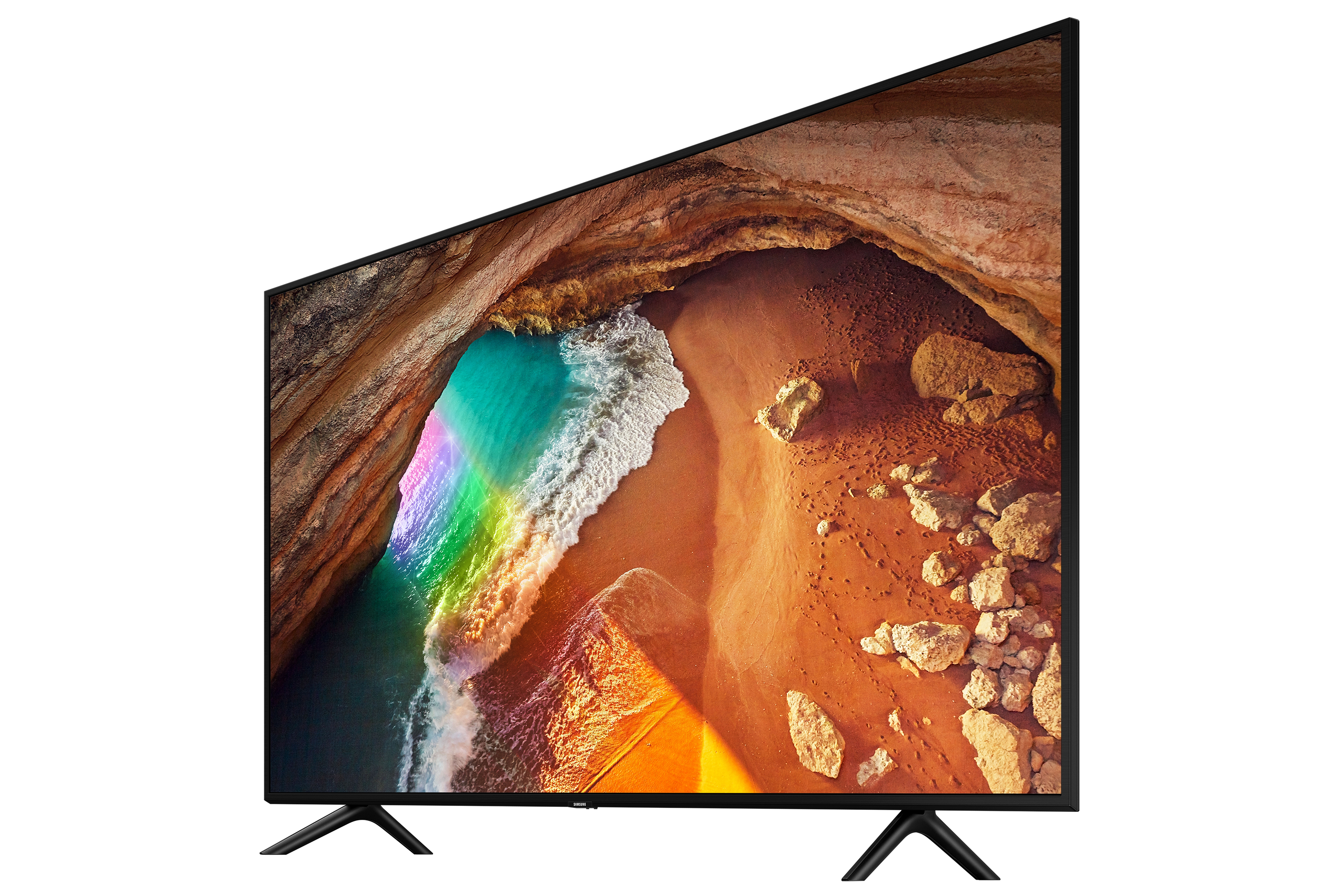 TV con scena di spiaggia e arcobaleno sullo schermo. Inclinato verso destra su superficie bianca.