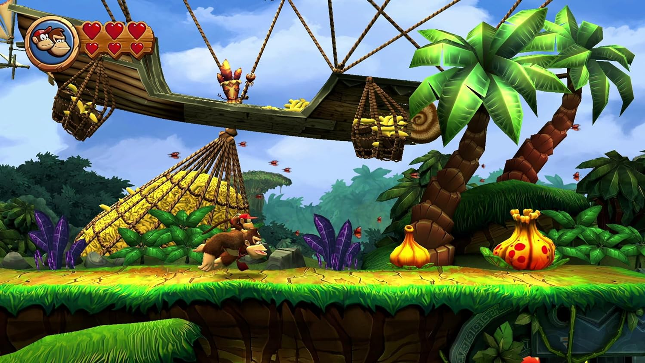 Donkey Kong biegnie po platformie, banany na statku i dżungla w tle.