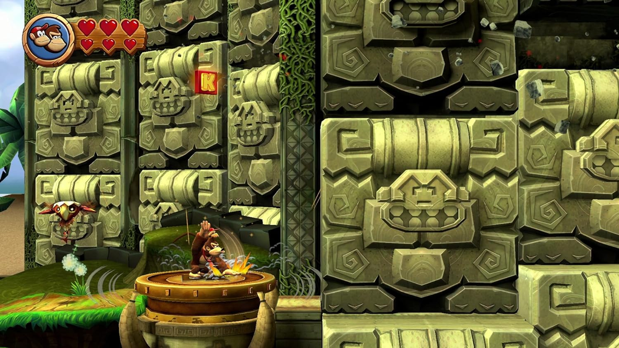 Donkey Kong w scenerii dżungli, z kamiennymi strukturami i literą K.