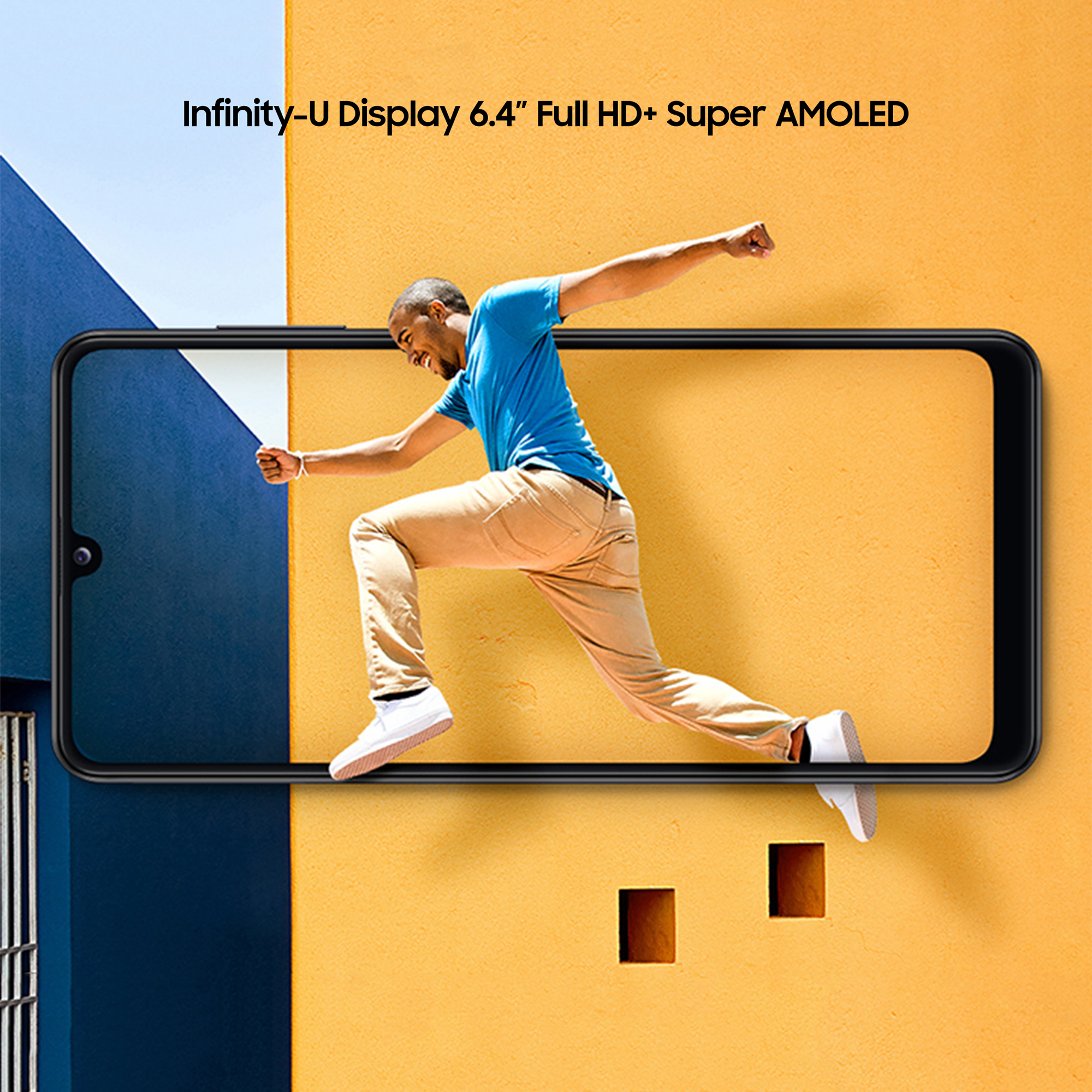 Ekran smartfona pokazujący skaczącego mężczyznę. Błękitne niebo i żółta ściana w tle.