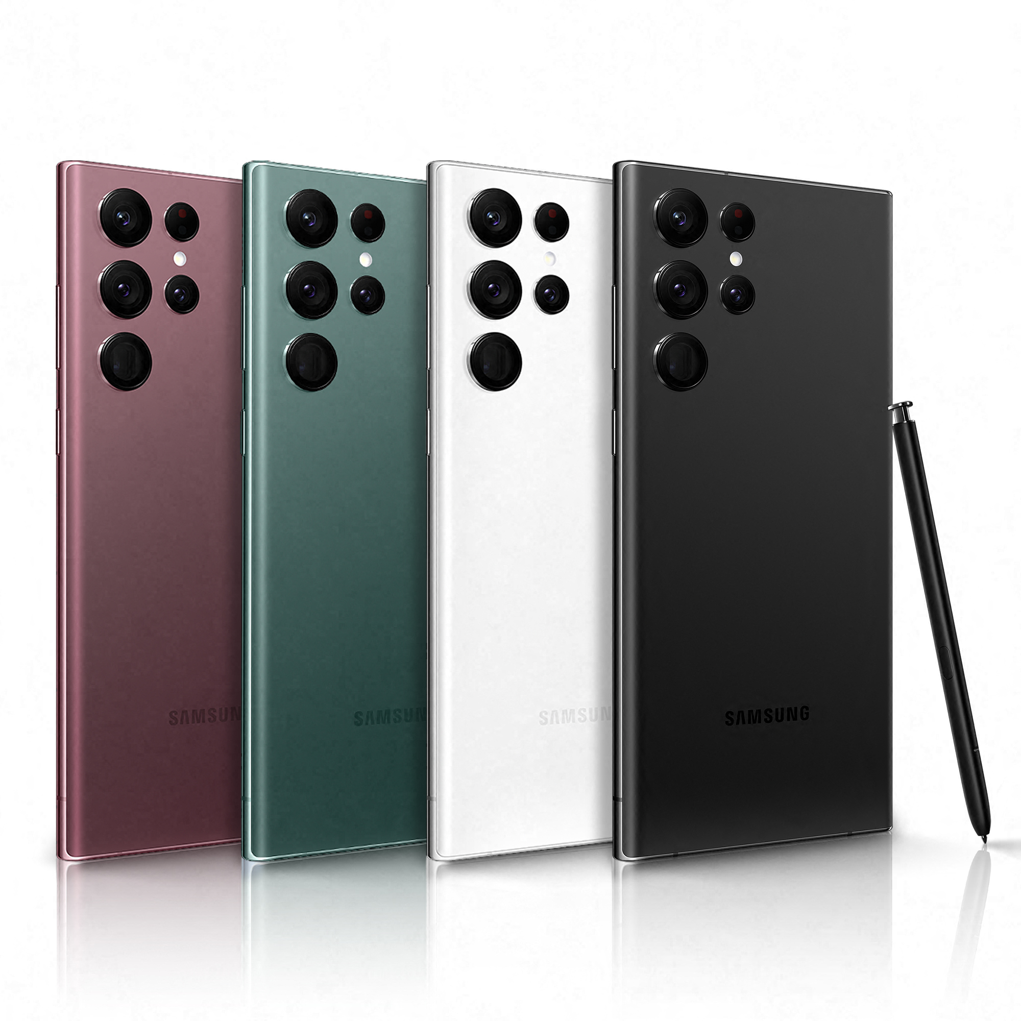 Vier Smartphones, verschiedene Farben. Schwarz, Weiß, Rot und Grün. Stift rechts.