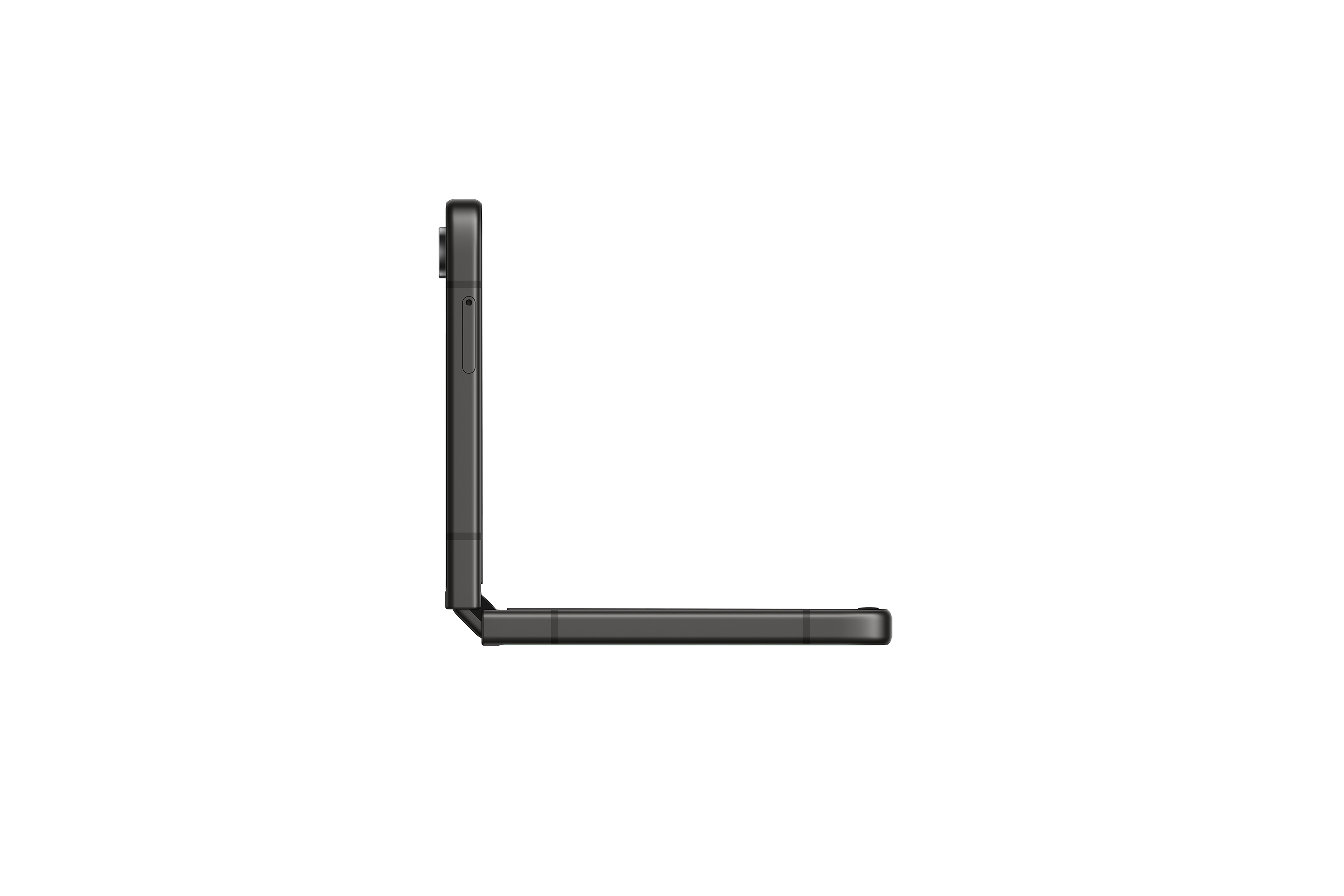 Złożony czarny telefon, widok z boku, spoczywający na białej powierzchni.