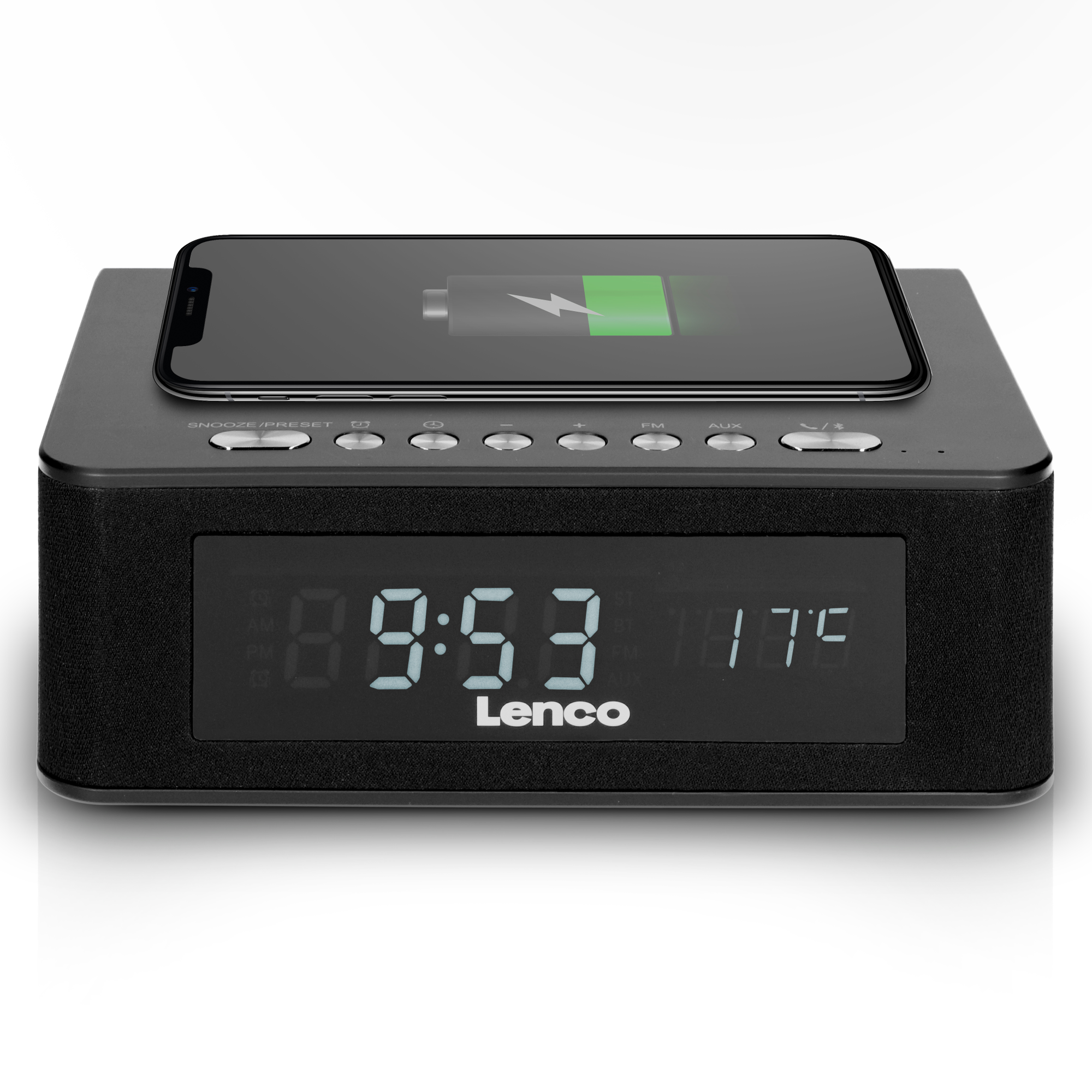 A phone charging on a black alarm clock, showing time and temperature.