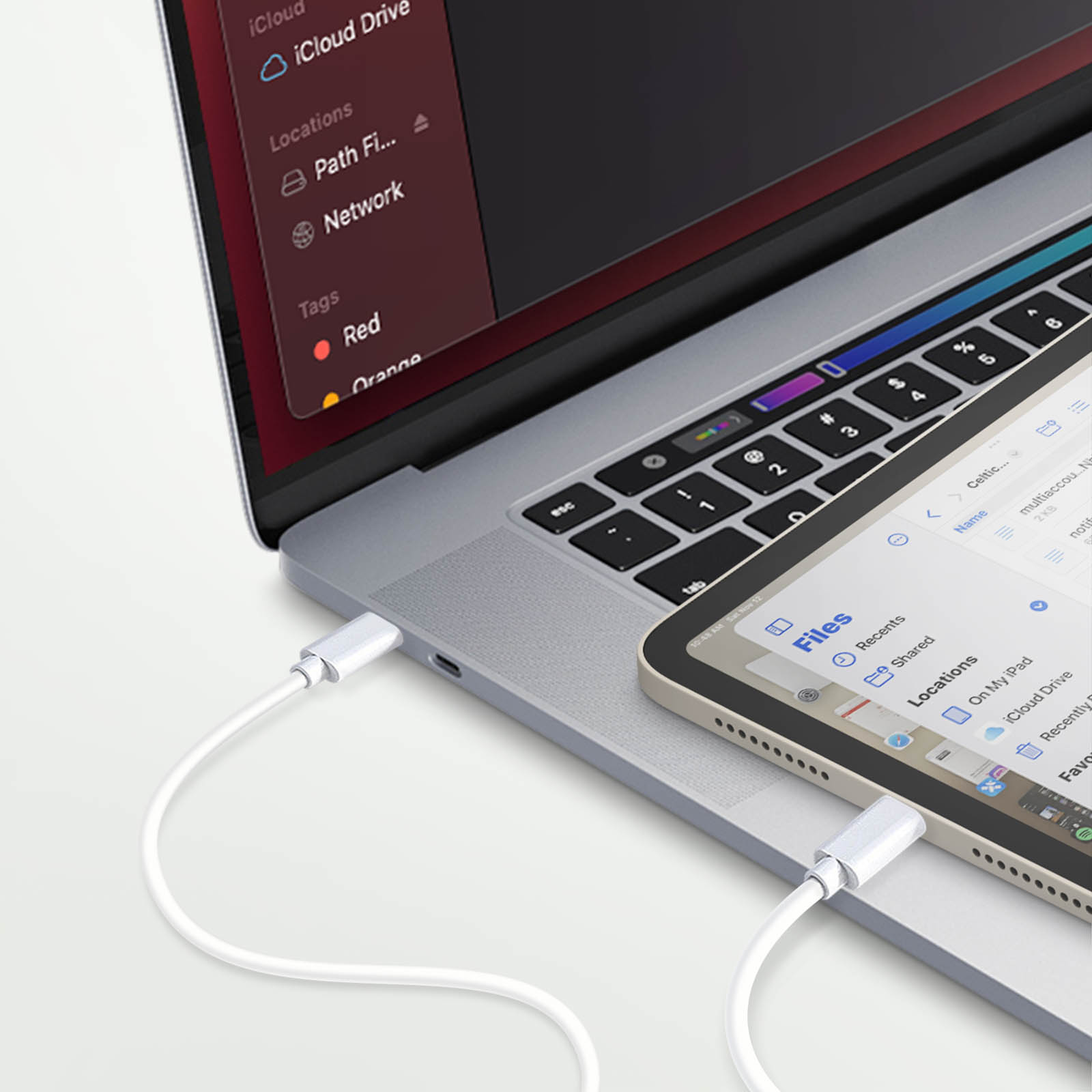Ein Laptop und ein iPad sind über ein weißes USB-C-Kabel verbunden.