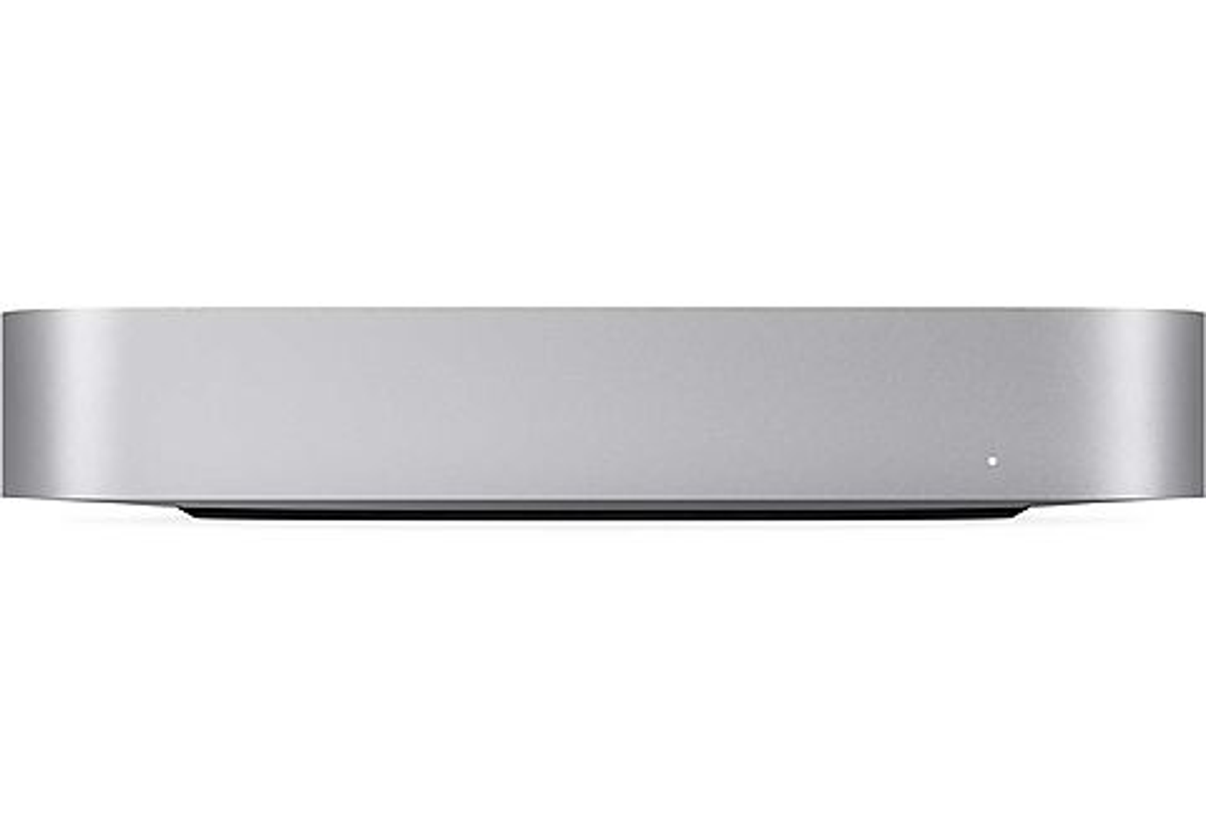 Un Mac Mini plateado, un ordenador pequeño y rectangular, sobre superficie blanca.