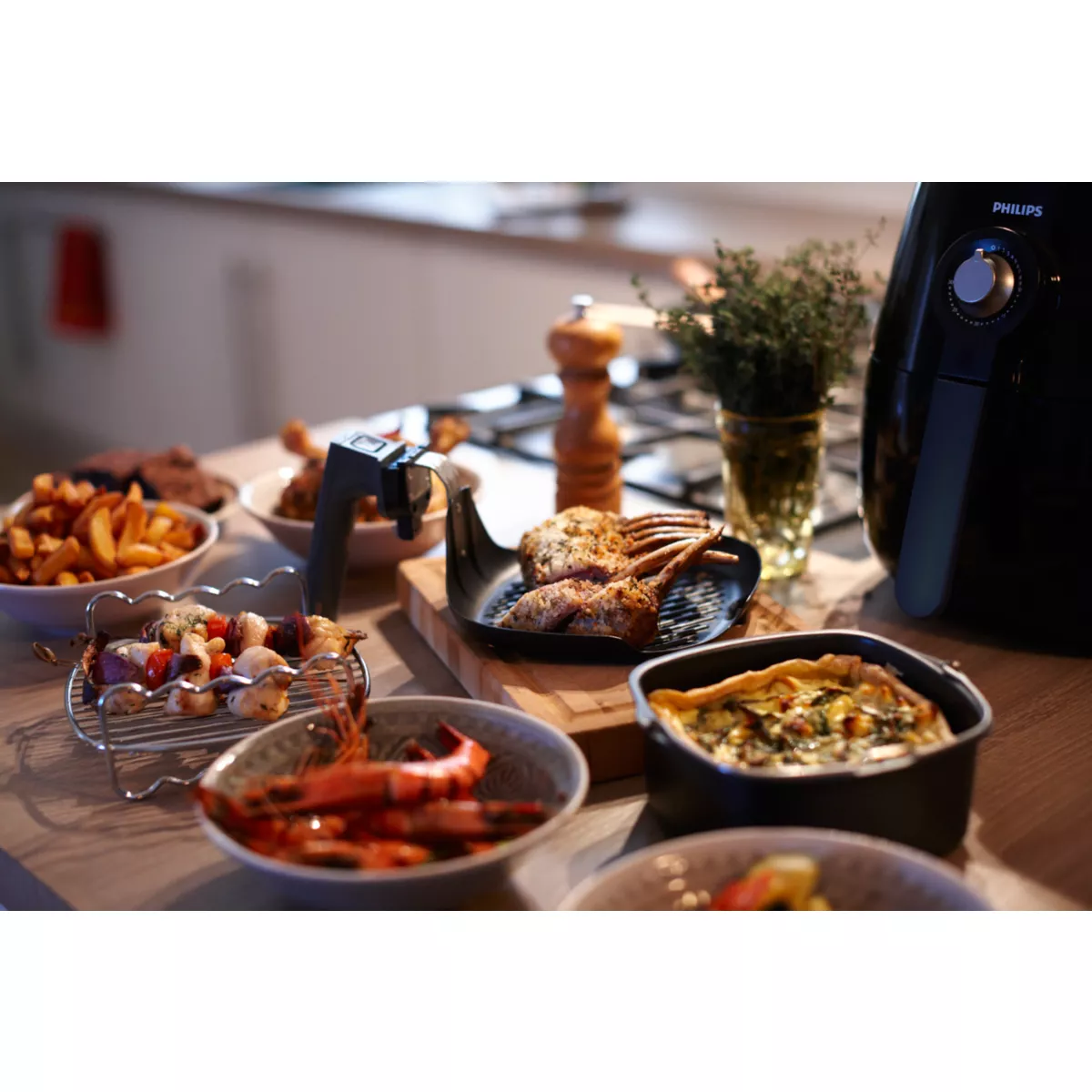 An air fryer with various cooked dishes, including fries, meat skewers, and shrimp.