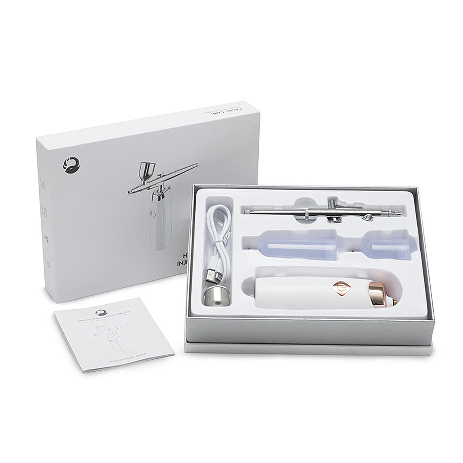 Una caja blanca abierta con un kit de aerógrafo dentro. Incluye una botella, manual de instrucciones y otros componentes.