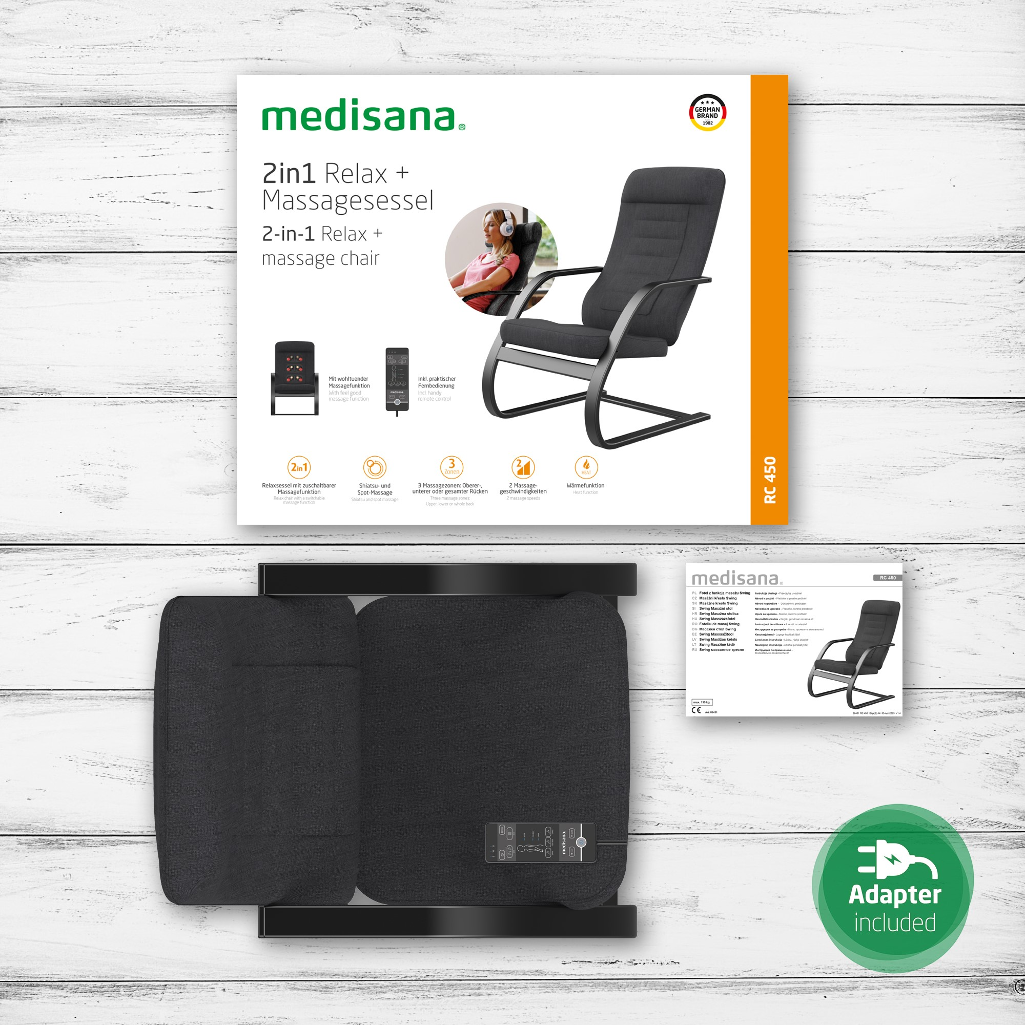 Box with a massage chair and related items on a wooden surface.