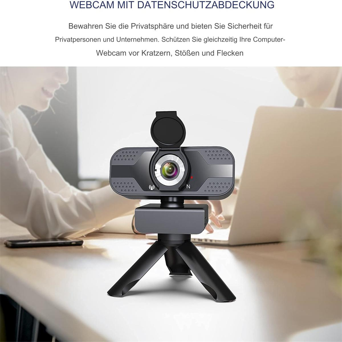 Webcam auf Stativ. Schwarz mit Linse und Abdeckung. Person benutzt Laptop im Hintergrund.