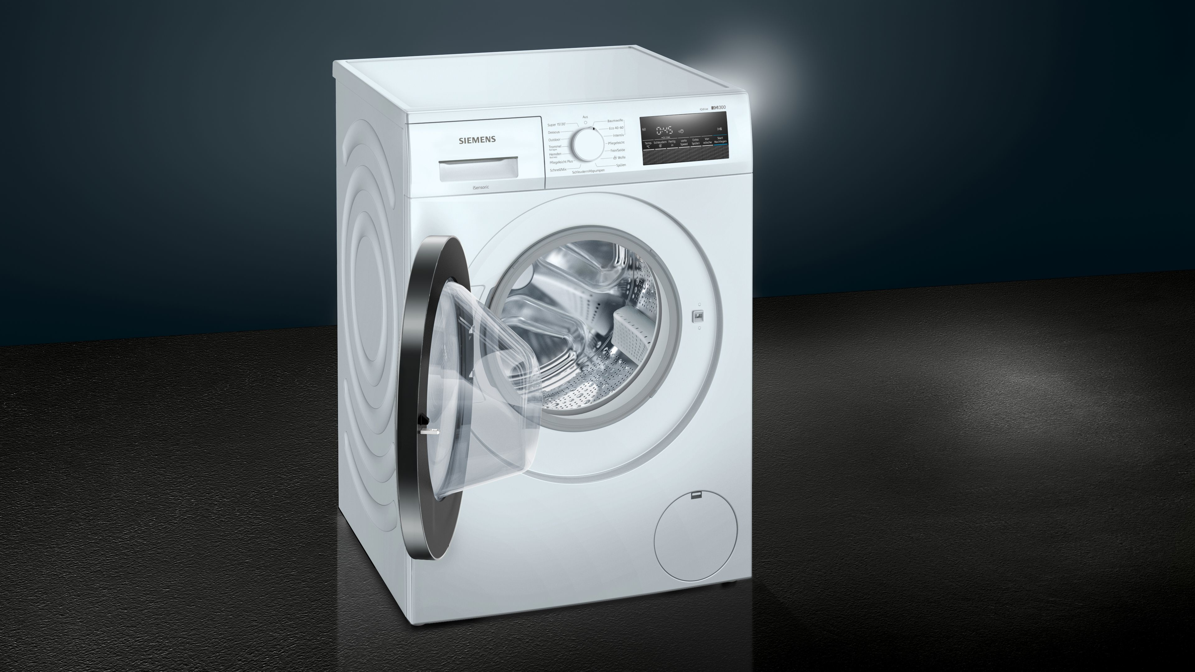 Lavatrice Siemens bianca con porta aperta, dettagli neri e argento, su sfondo blu scuro.