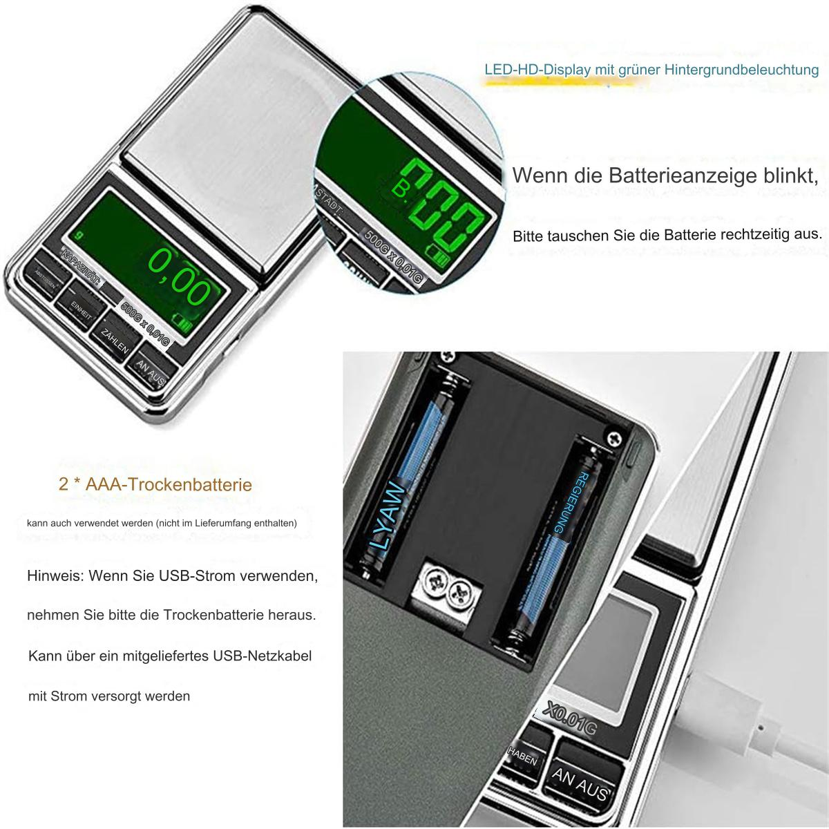 Digitale Waage mit Anzeige, die Zahlen zeigt. Batterien und USB-Kabel sichtbar.
