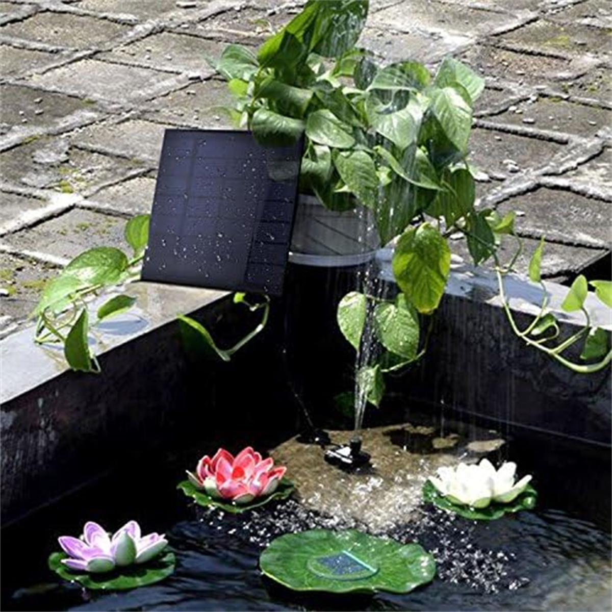 Ein solarbetriebener Springbrunnen mit Pflanzen, Seerosen und einem kleinen Wasserfall in einem Steinbecken.