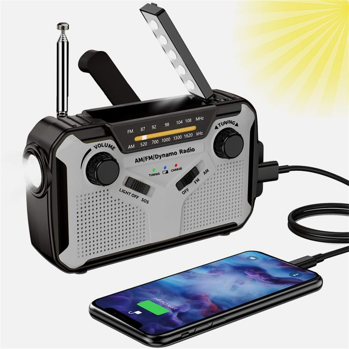 Ein schwarz-graues AM/FM/Dynamo-Radio mit Taschenlampe und Ladetelefon. Zeigt Tuning und Aufladung.