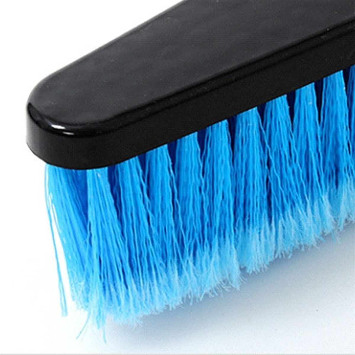 Eine schwarze Bürste mit blauen Borsten, Nahaufnahme.