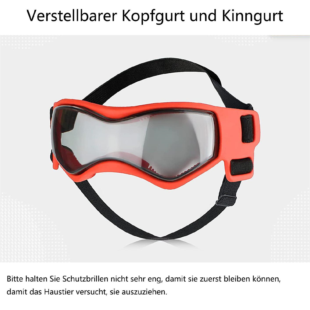 Orangefarbene Hundeschutzbrille mit schwarzen Trägern, von niemandem getragen. Die Brille liegt auf weißem Grund.