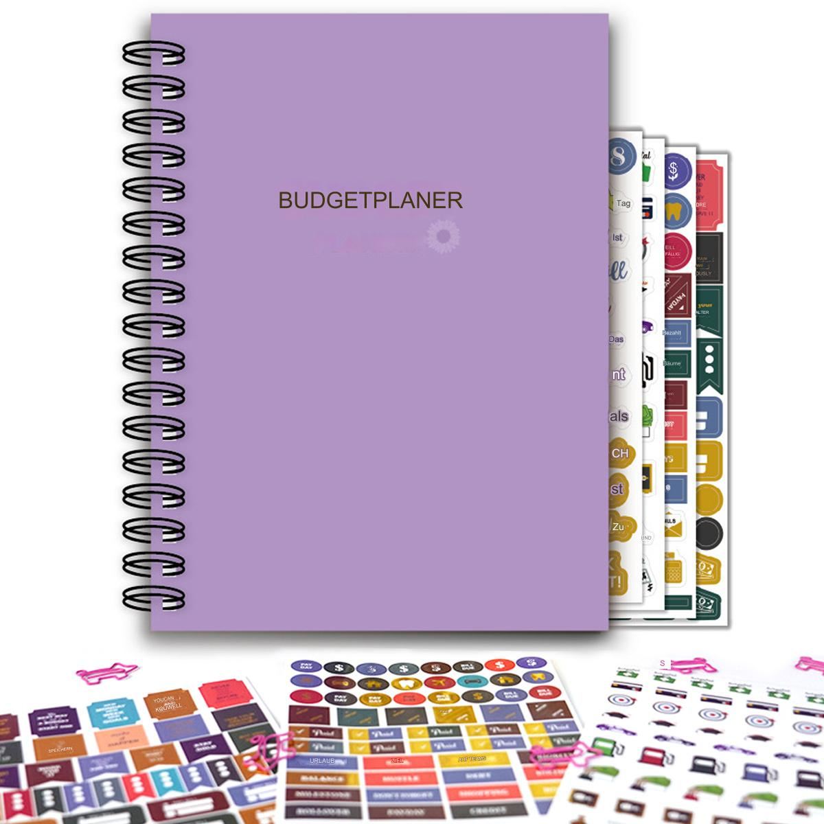 Lila Budgetplaner mit Aufklebern und ein Notizbuch mit Spiralbindung.