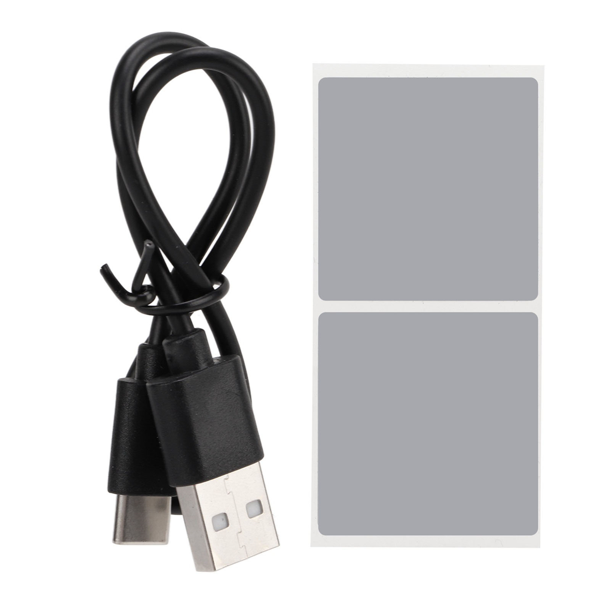Ein schwarzes USB-Kabel und zwei graue Aufkleber.