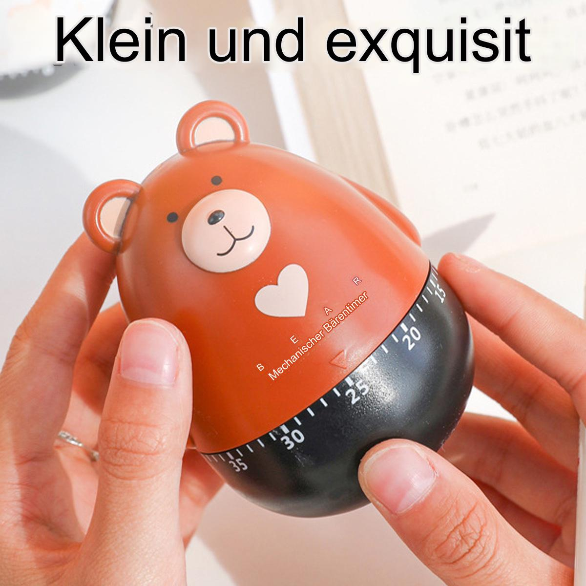 Ein bärenförmiger Küchentimer, schwarz und braun mit weißem Herz und Zahlen.