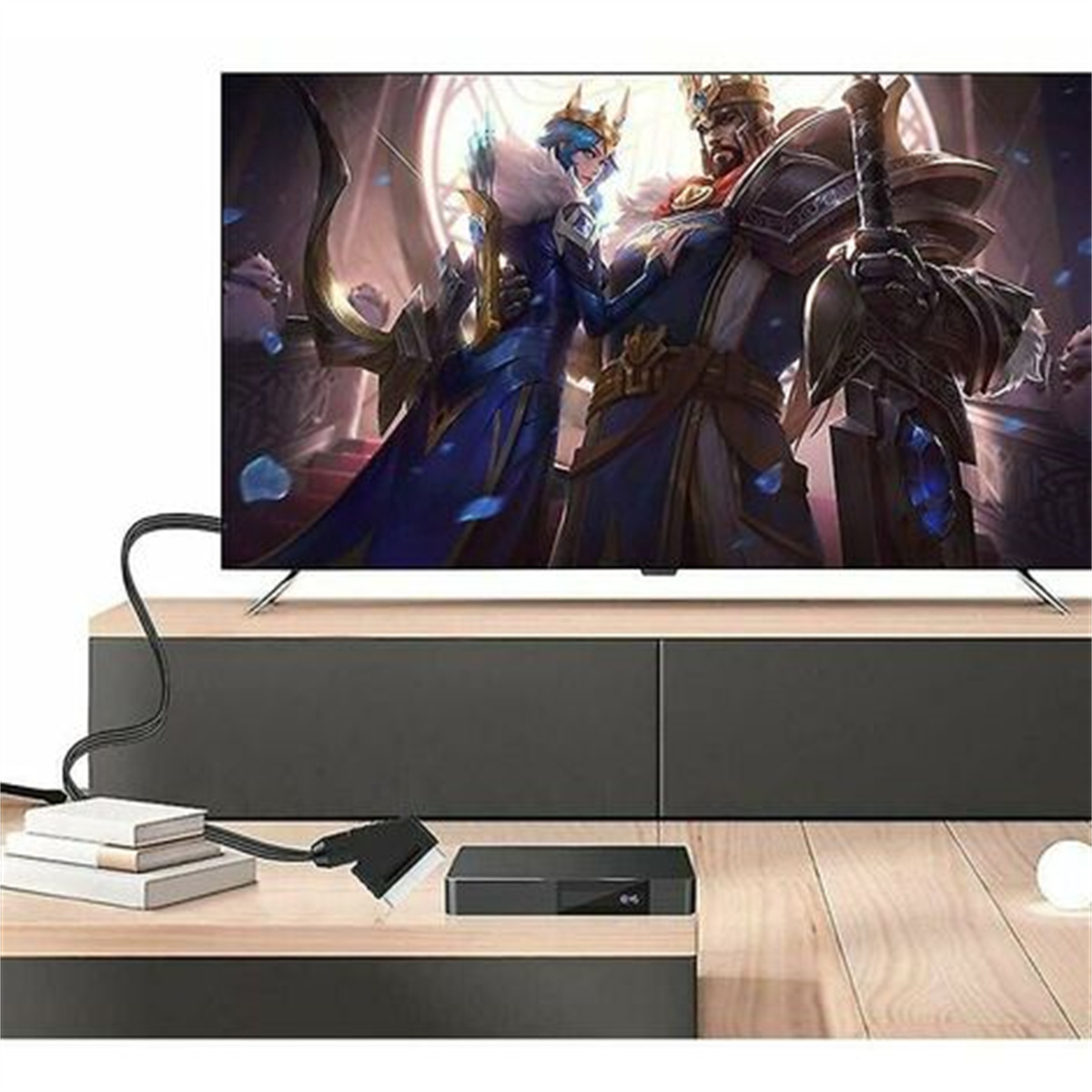 Fernseher mit Fantasy-Szene, Receiver und SCART-Kabel auf einem Holztisch.
