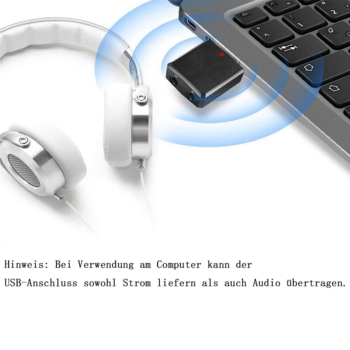 Kopfhörer und ein schwarzer Bluetooth-Adapter, der mit einem Laptop verbunden ist, mit rotem Licht.
