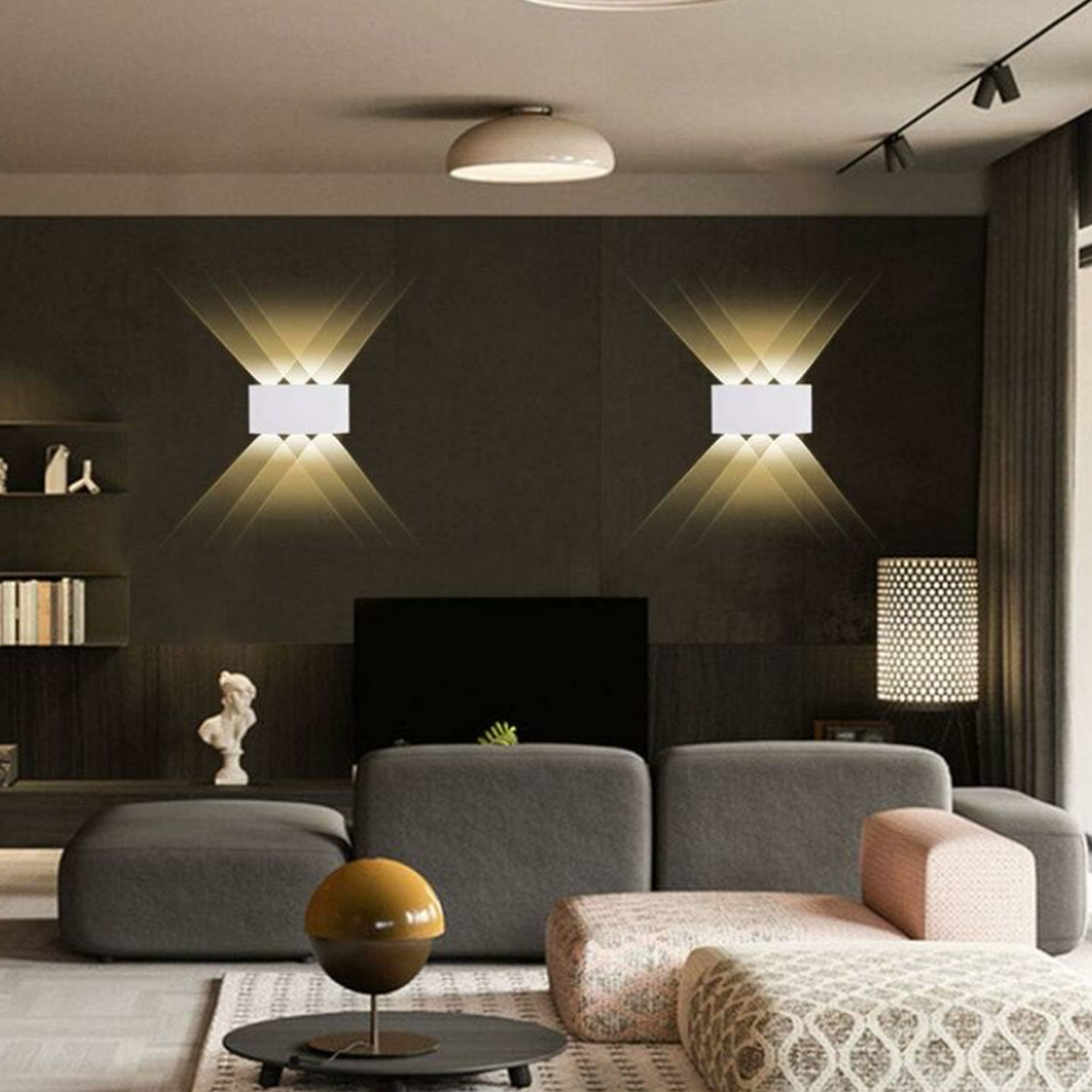 Modernes Wohnzimmer mit zwei Wandleuchten, Sofa, Couchtisch und dunkler Wand.