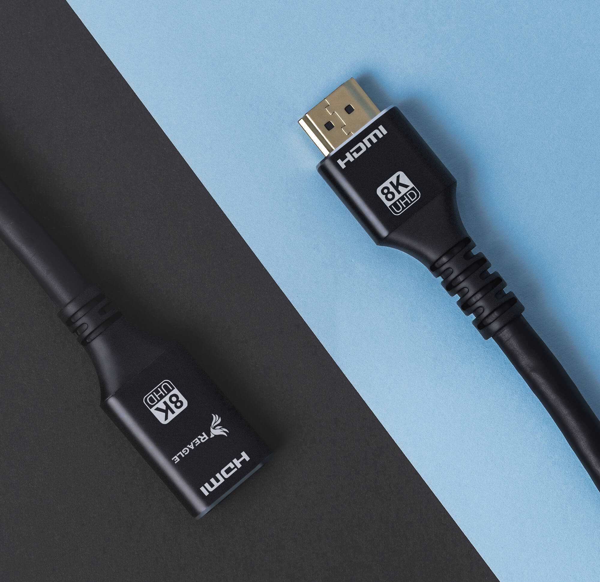 Dwa czarne kable HDMI ze złączami, jeden z etykietą, na czarno-niebieskim tle.