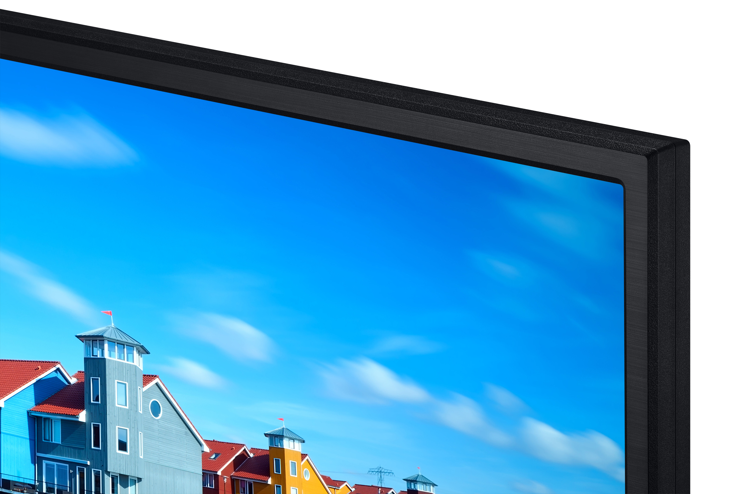 TV-Ecke mit blauem Himmel und bunten Häusern im Hintergrund.