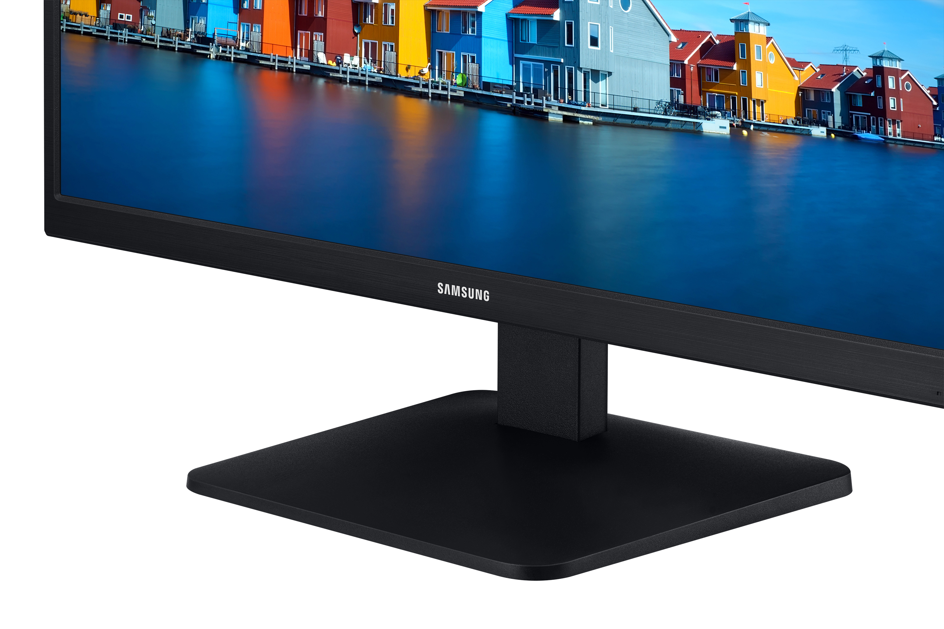Ein schwarzer Computermonitor mit einem lebendigen Bild von bunten Häusern an einem Gewässer.