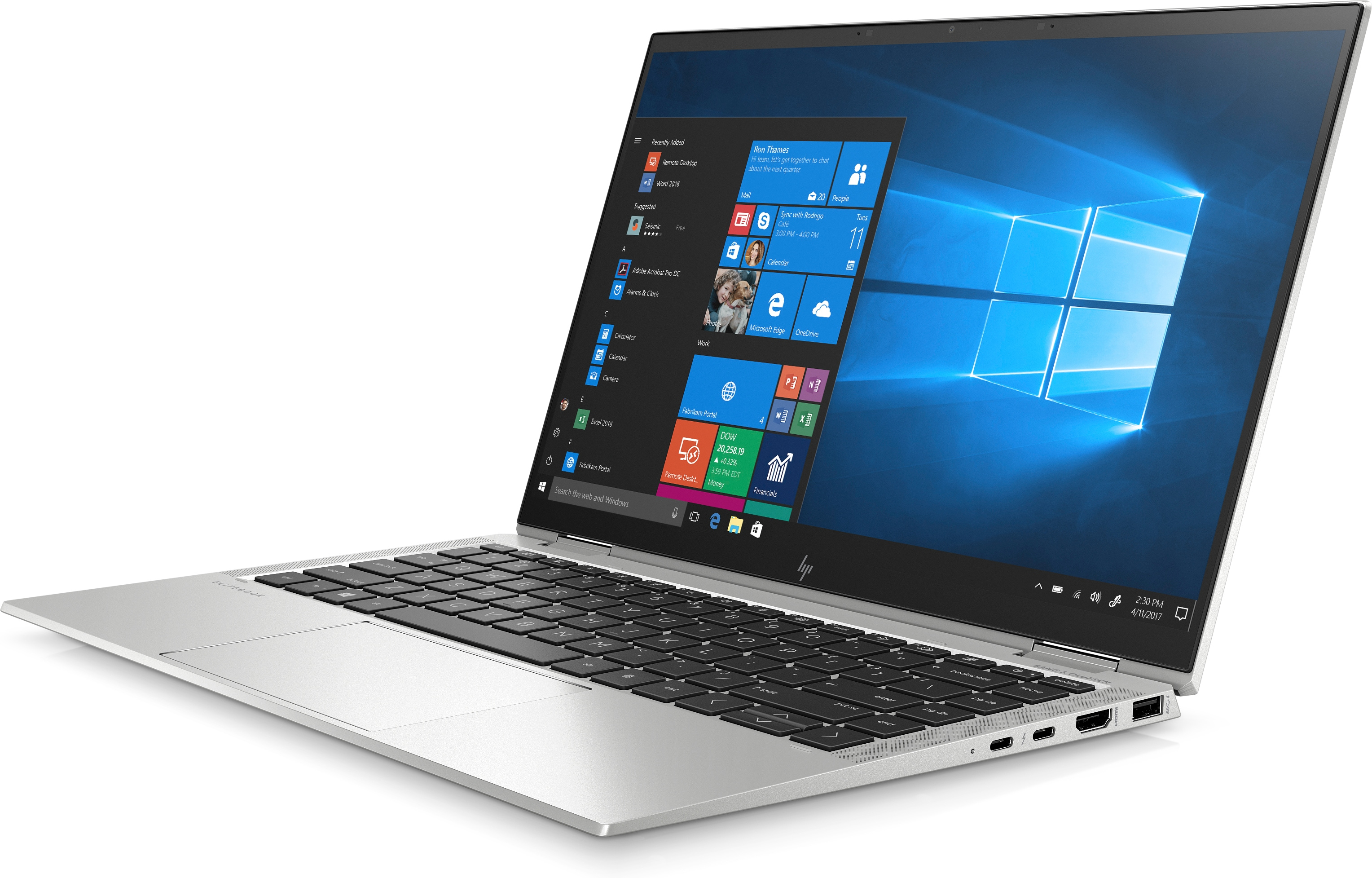 Portátil plateado con pantalla abierta. Muestra la interfaz de Windows. Teclado visible. Fondo blanco.