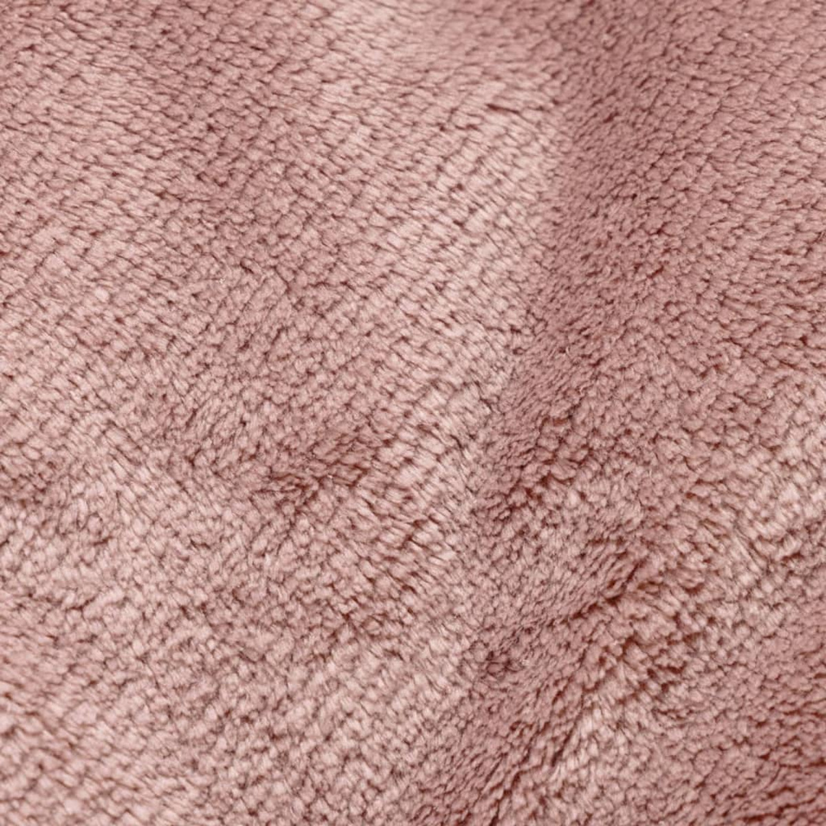Nahaufnahme einer rosa, flauschigen Oberfläche, wahrscheinlich Stoff oder ein Teppich.
