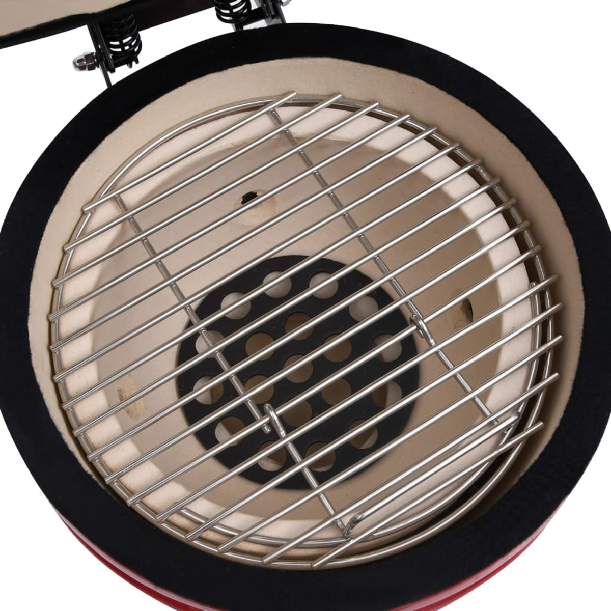 Keramik-Grill-Innenraum mit Metallrost und schwarzem, kreisförmigem Rand.