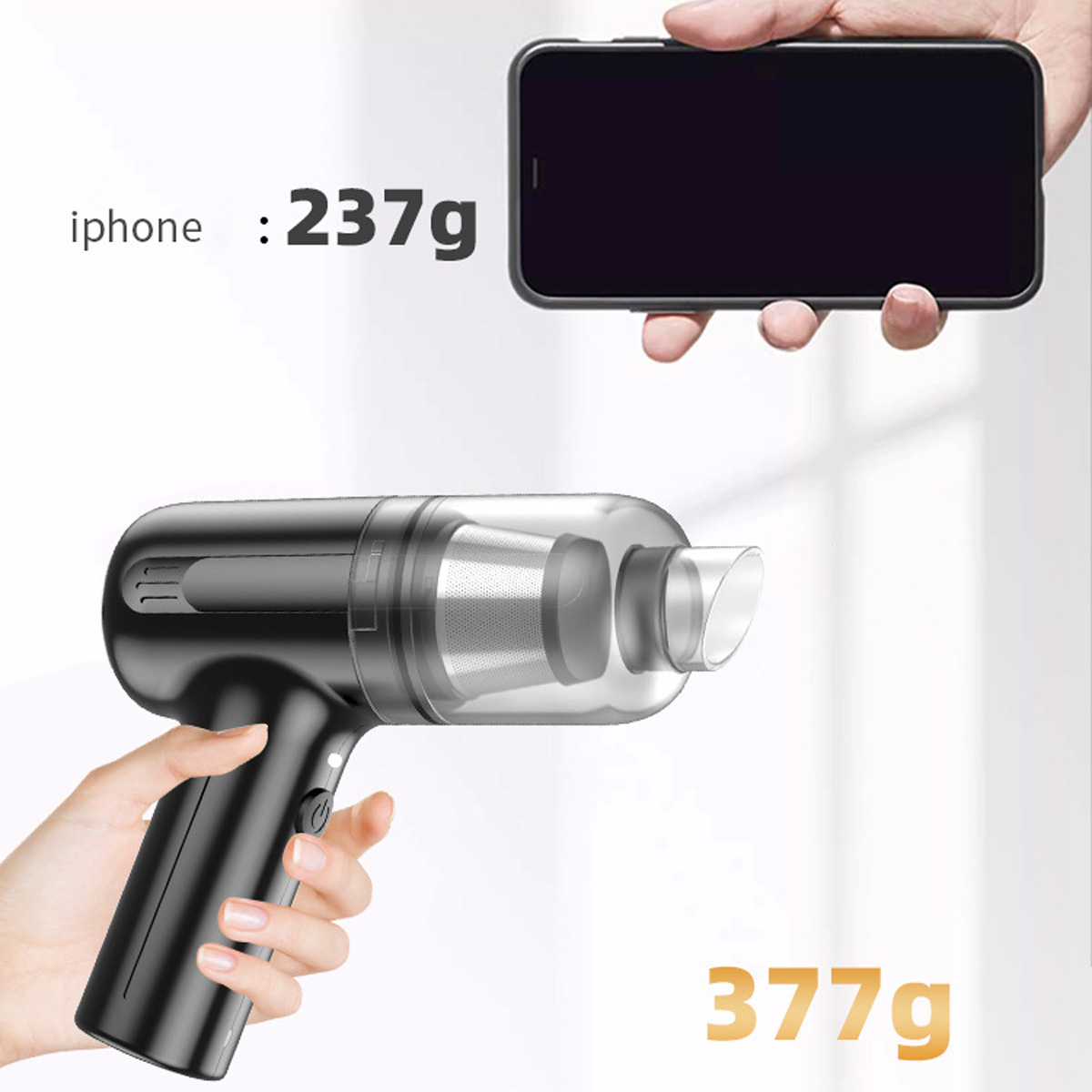 Czarny odkurzacz ręczny trzymany przez dłoń obok telefonu.