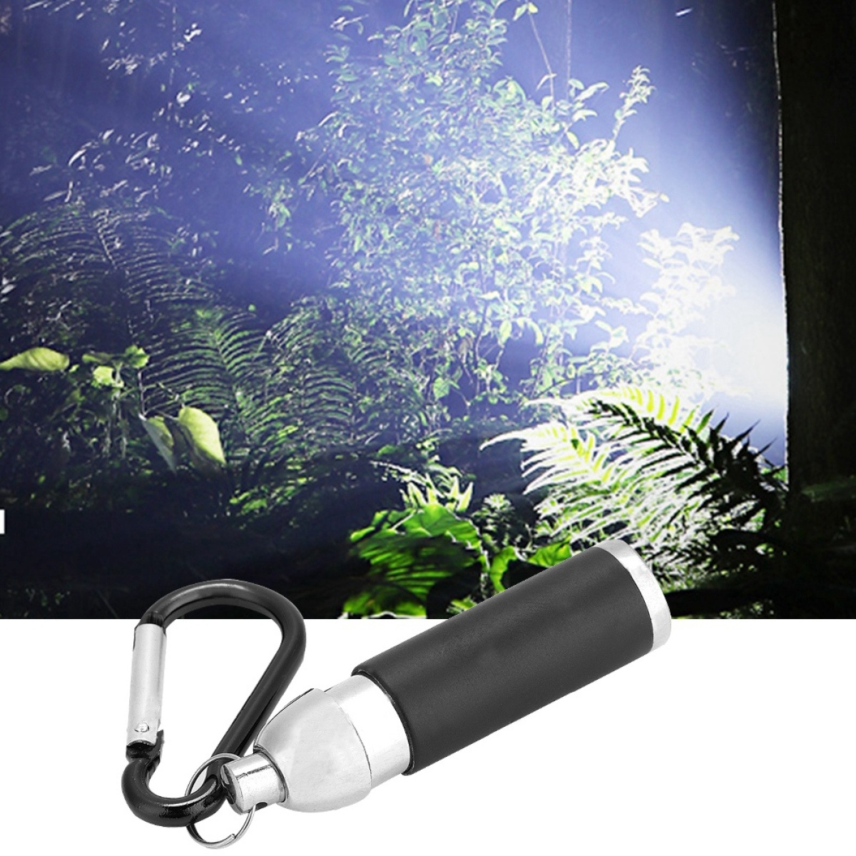 Schwarze Taschenlampe mit silbernem Clip, in dunkler, beleuchteter Waldumgebung.