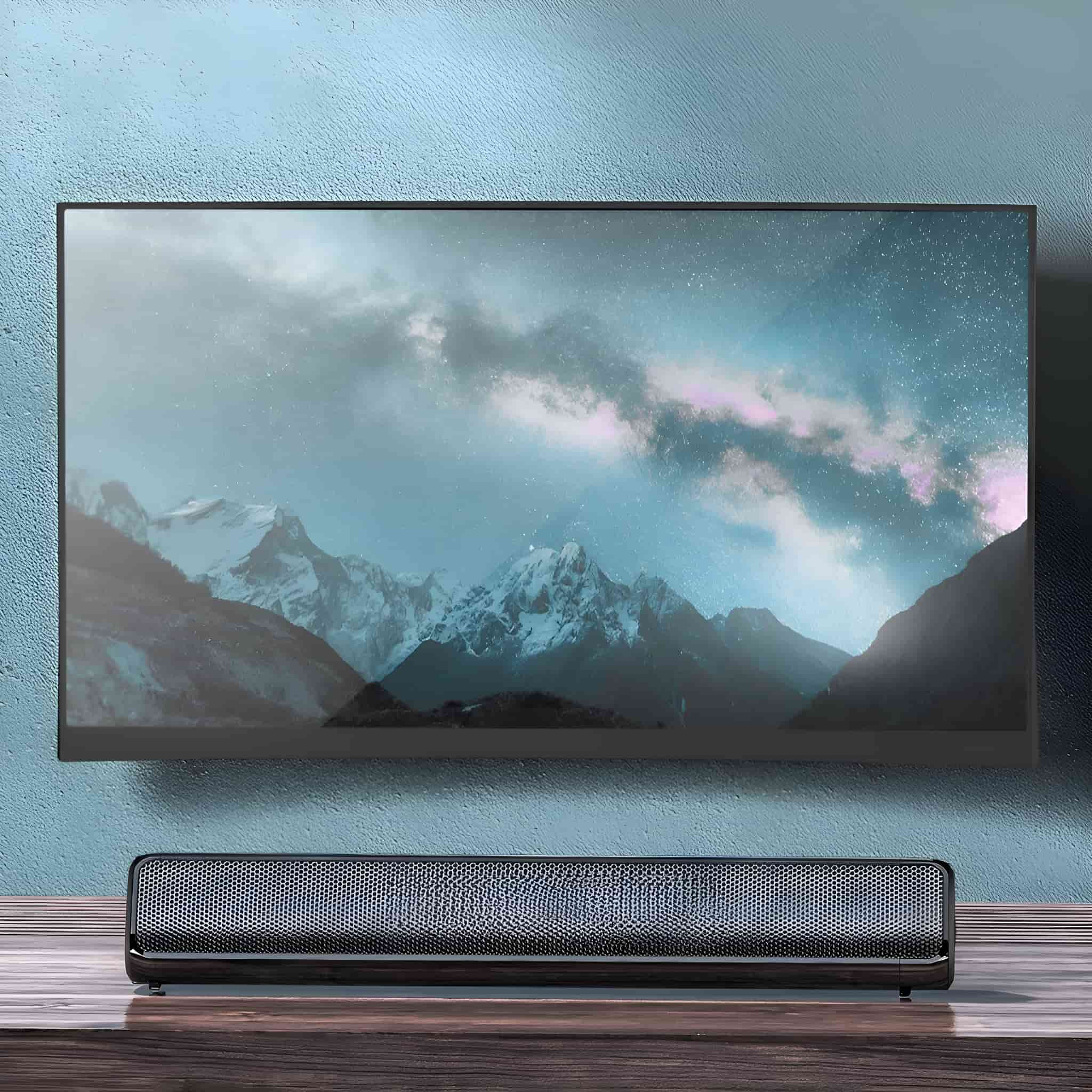 Ein moderner Fernseher an einer blauen Wand. Eine Soundbar darunter, mit einer Landschaftsszene auf dem Bildschirm.